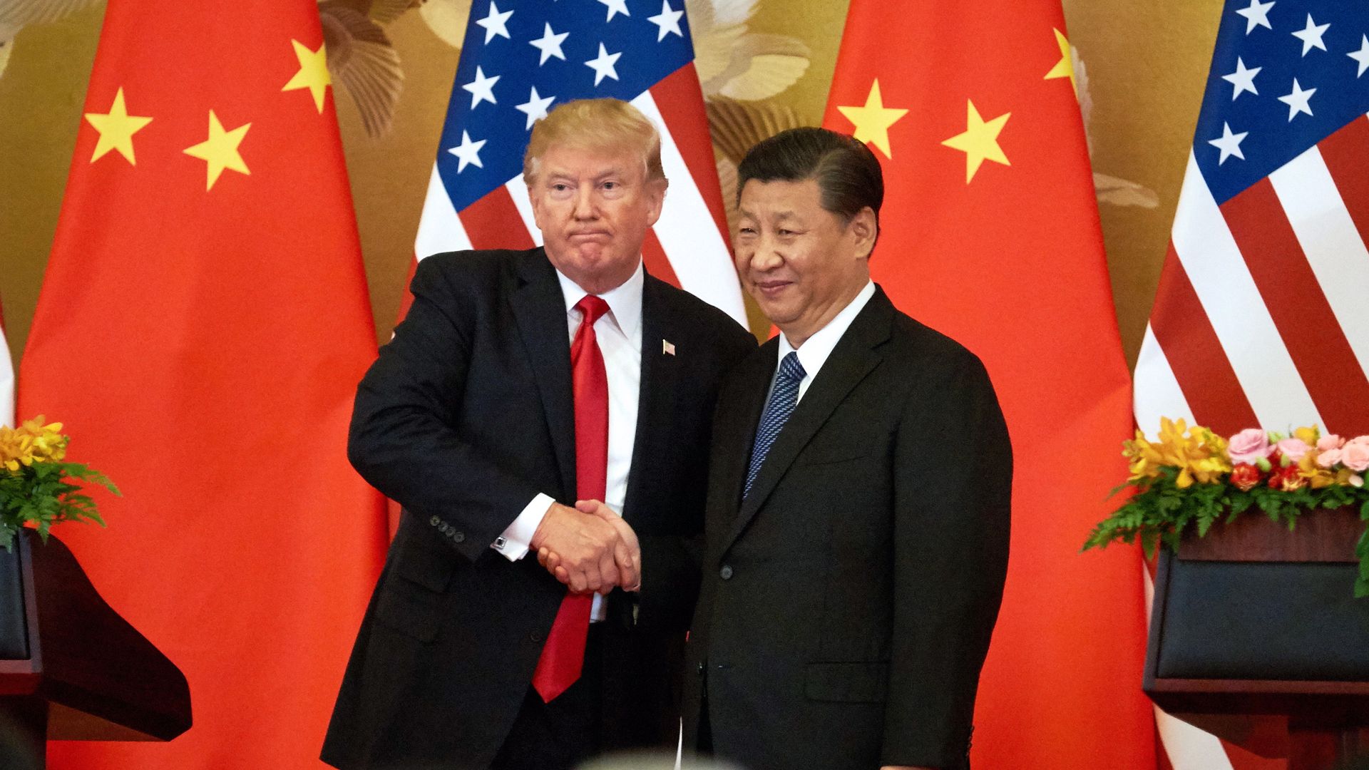 Trump and Xi shake hands.