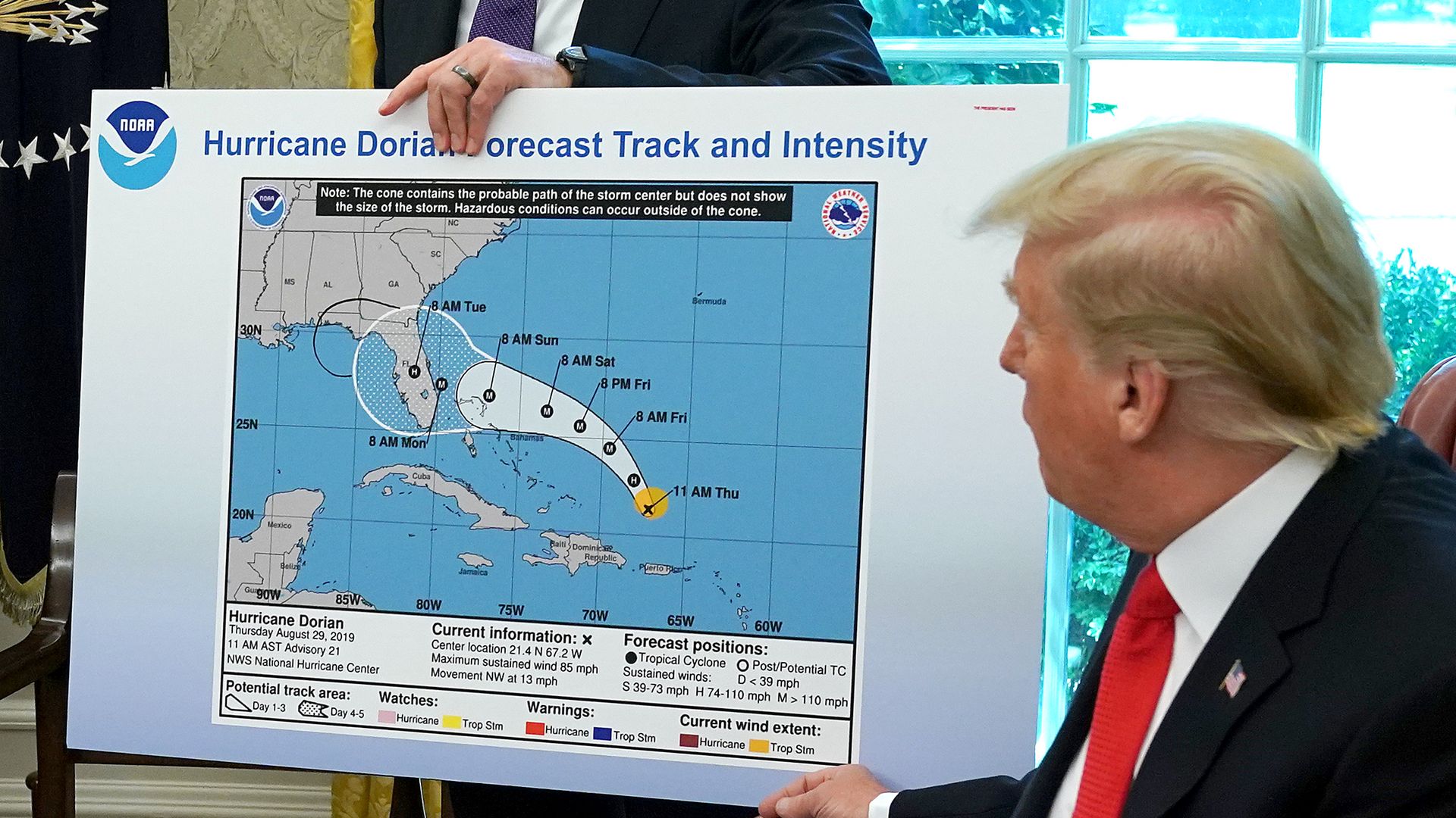 President Donald Trump points to a modified map showing the path of Hurricane Dorian.