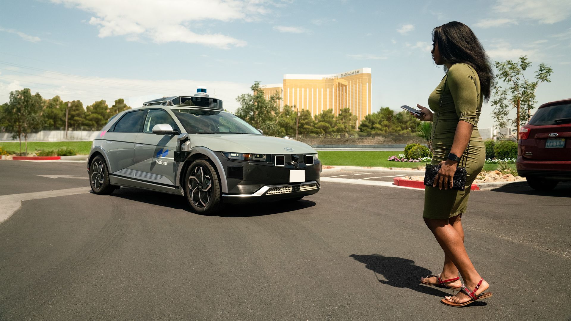 A woman prepares to board an autonomous Lyft robotaxi in Las Vegas
