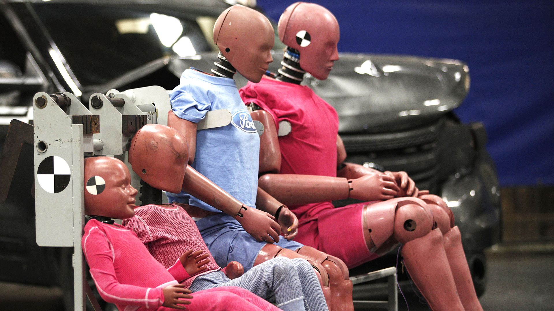 a family of crash test dummies at an auto testing site