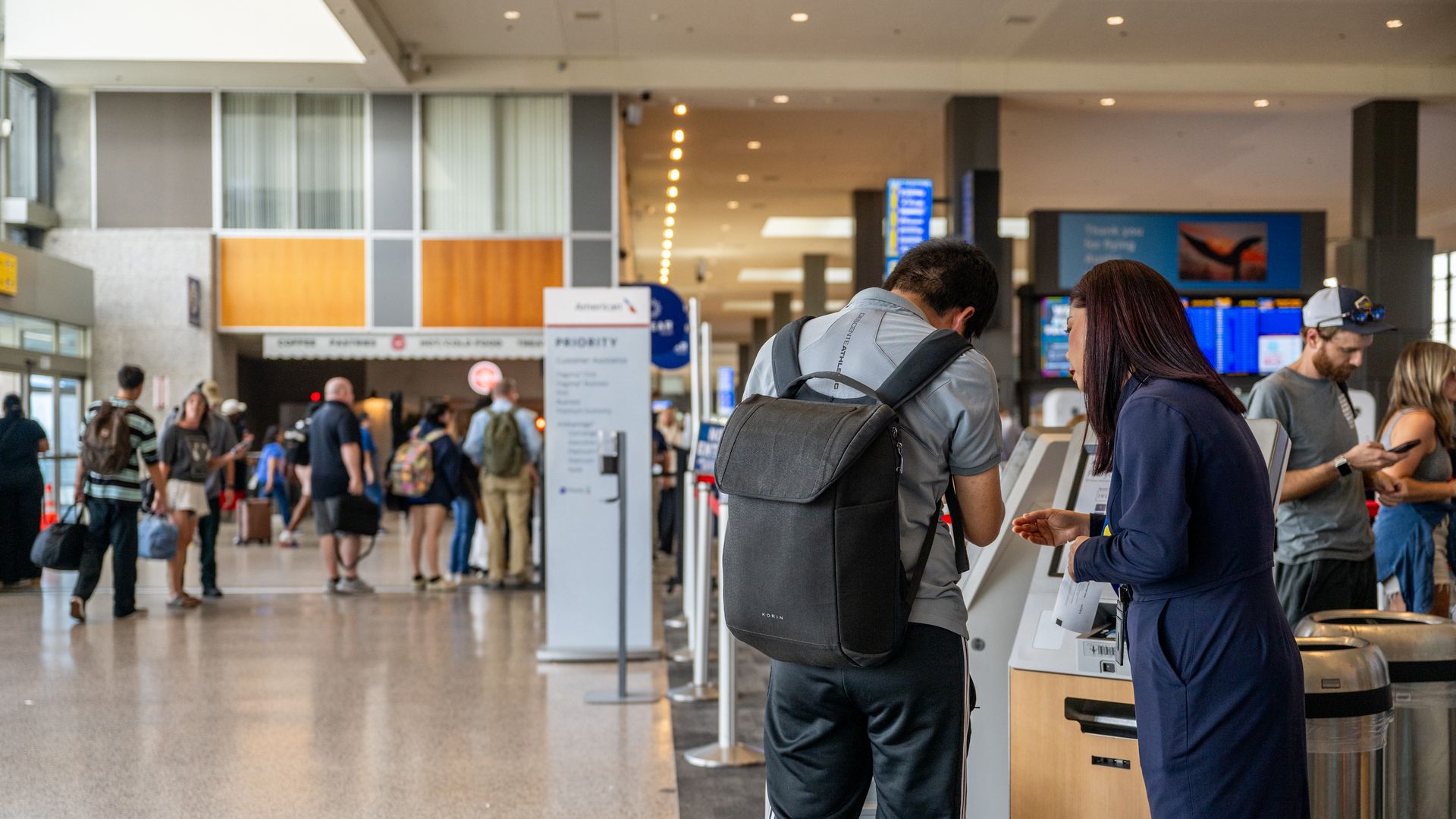 A ticket agent helps a passenger at the Austin airport.