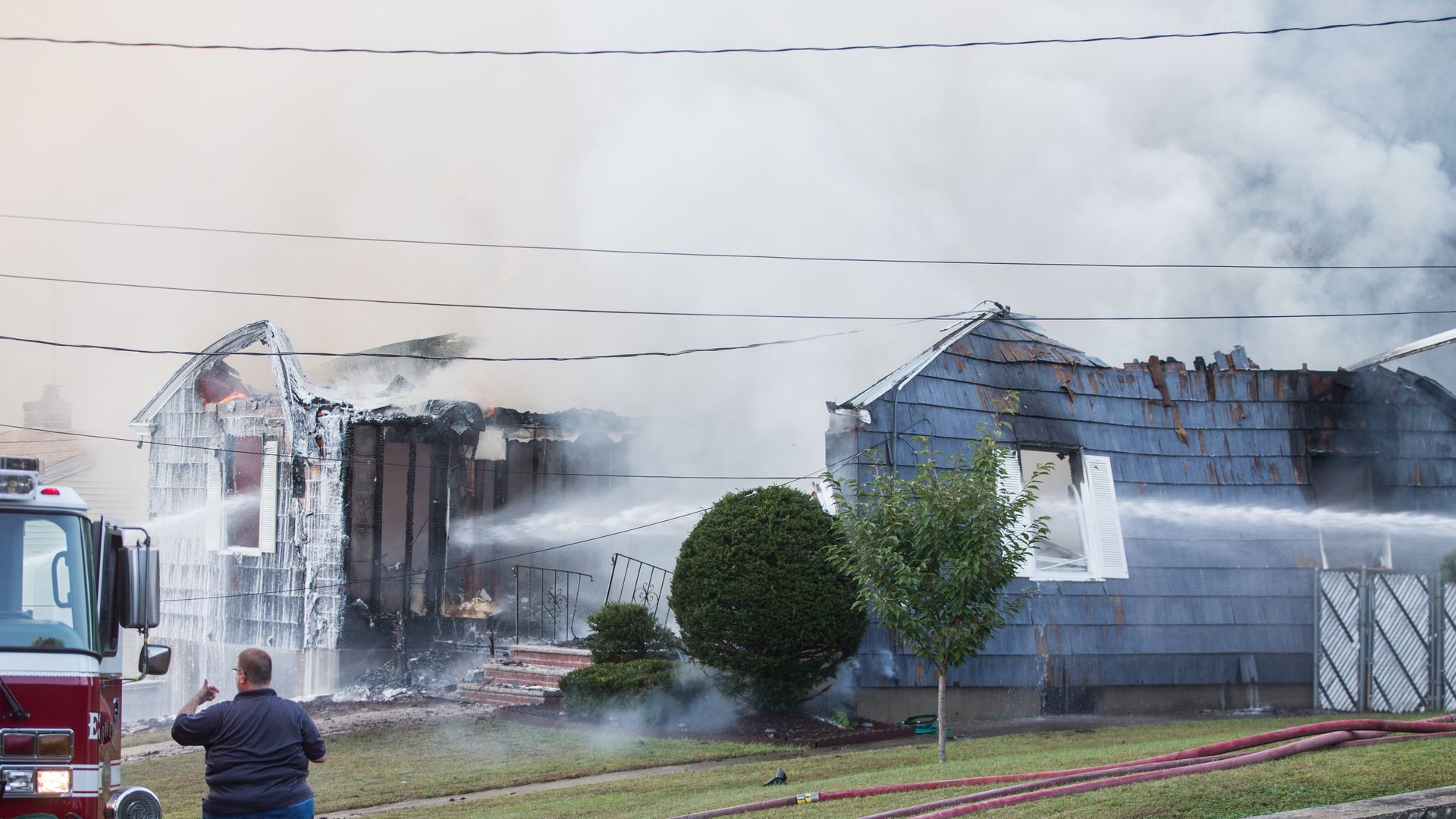 Firefighters in Massachusetts hosing a home