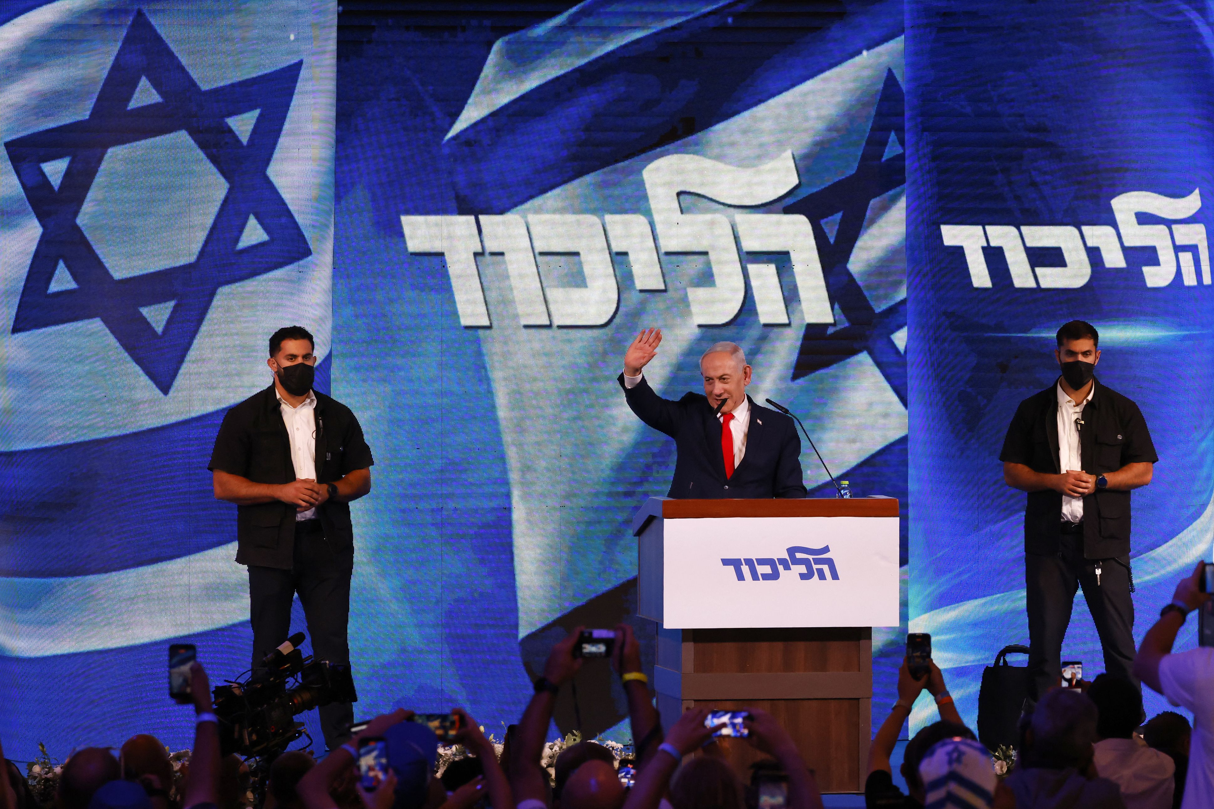Israel's Prime Minister Benjamin Netanyahu waves to his supporters at the election night rally in Jerusalem.