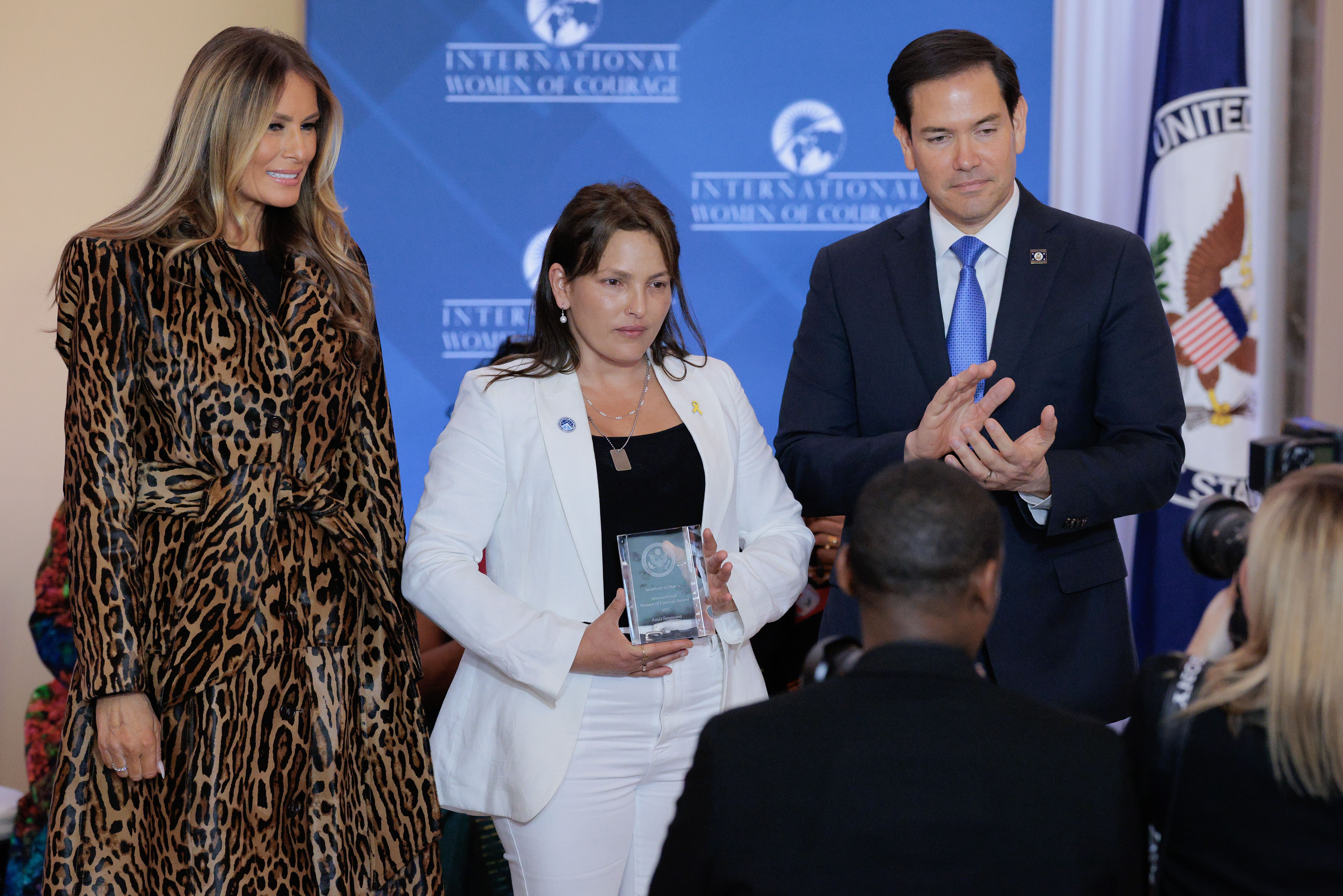  First lady Melania Trump (L) and Secretary of State Marco Rubio pose with International Women of Courage Award recipient Amit Soussana of Israel during a ceremony in the Ben Franklin Room at the State Department's Harry S. Truman headquarters on April 01, 2025 in Washington, DC. 