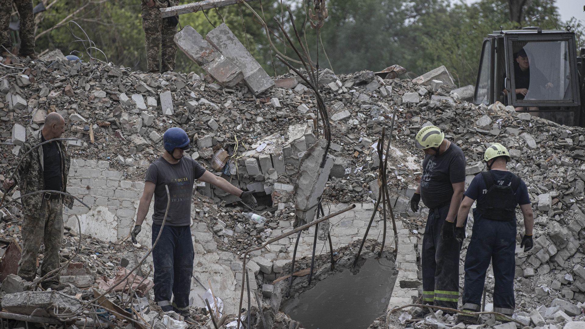  Firefighters conduct search and rescue operations on debris of buildings after Russian airstrikes hit residential areas in Chasiv Yar, Donetsk, Ukraine on July 11