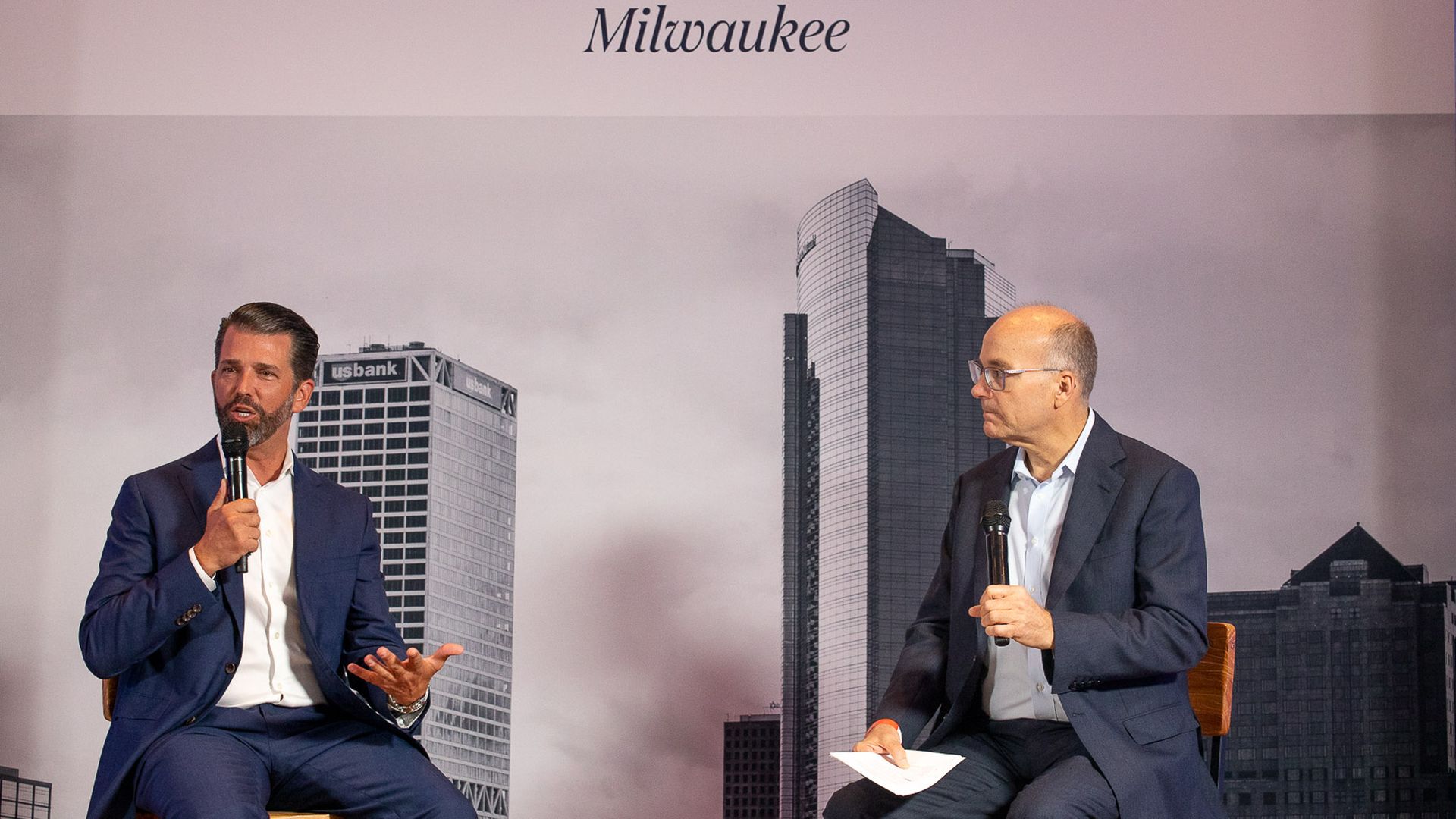 Photo of Donald Trump Jr. and Mike Allen on stage. 