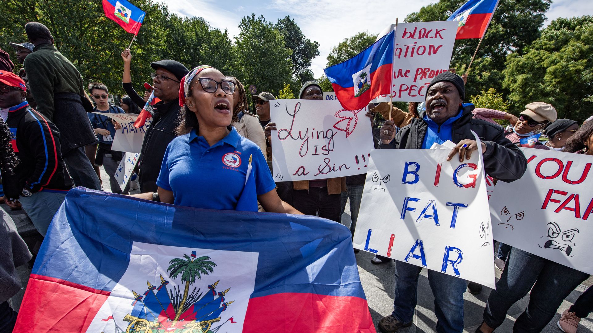 People participate in a rally in solidarity with the Haitian community in Boston.