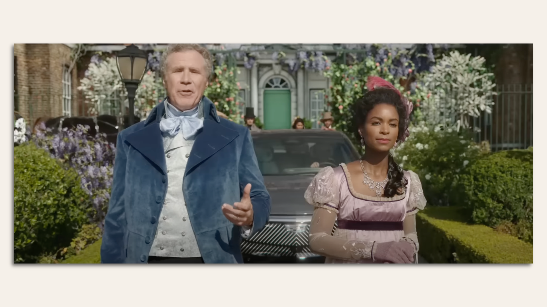 Man and woman dressed in Victorian attire walking in front of an electric vehicle