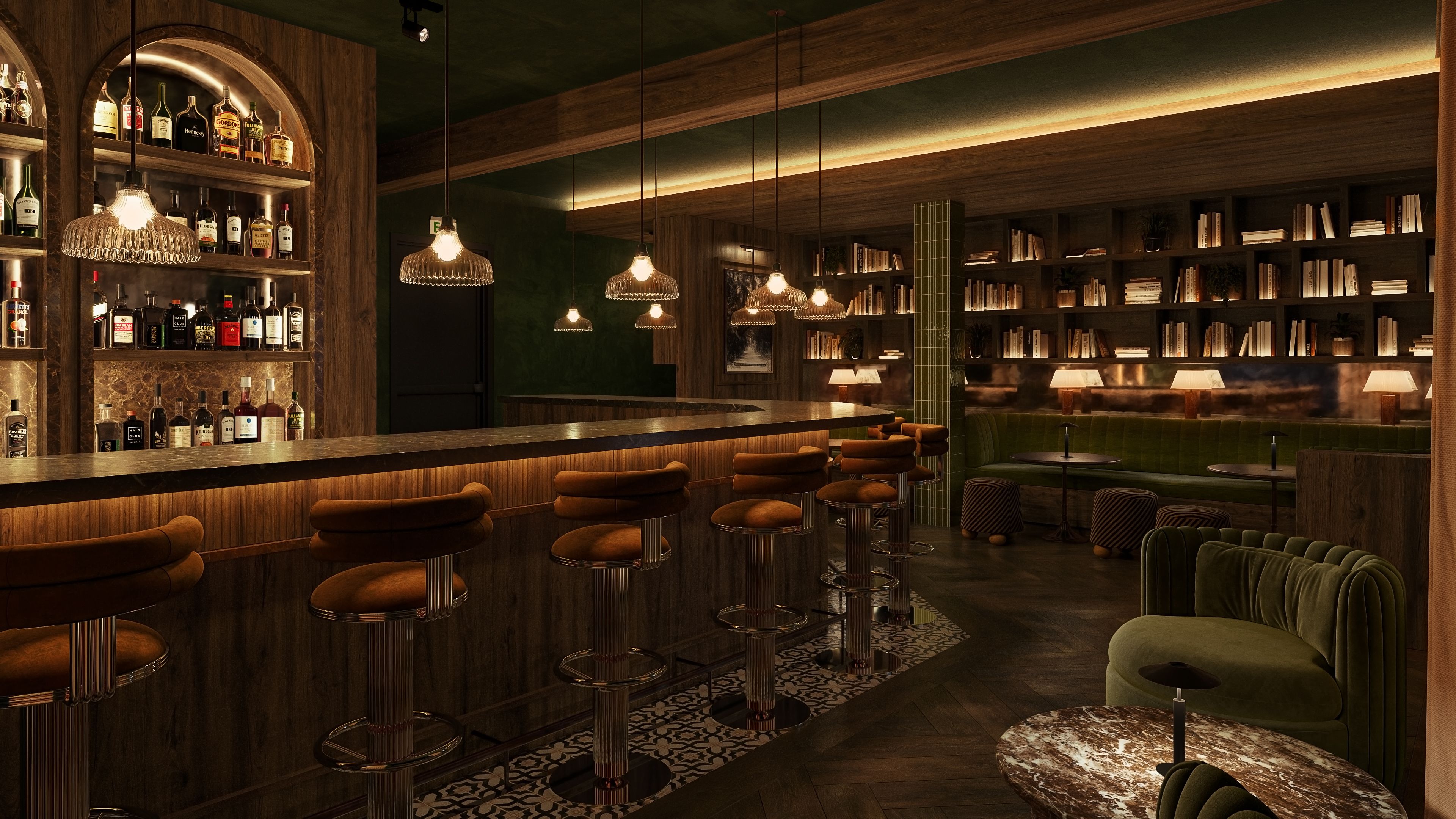 Cozy bar with warm lighting, brown cushioned bar stools, wooden shelves with bottles, green velvet seating, patterned floor tiles, pendant lights, and bookshelves lining the back wall.
