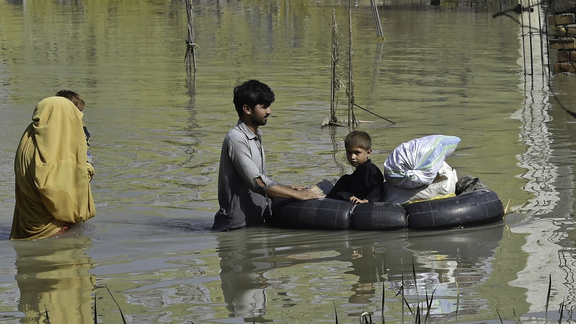 People wade through floodwaters in Pakistan.