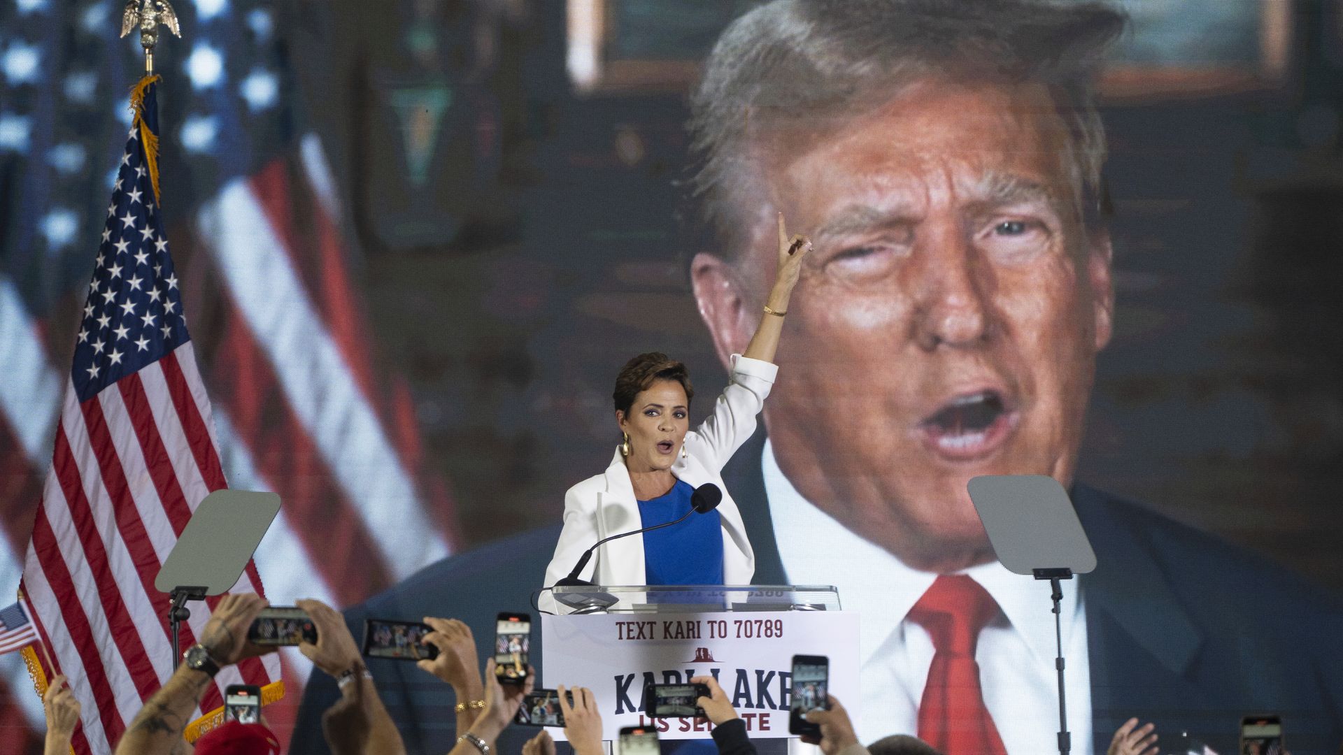 Kair Lake in front of a screen with Donald Trump.
