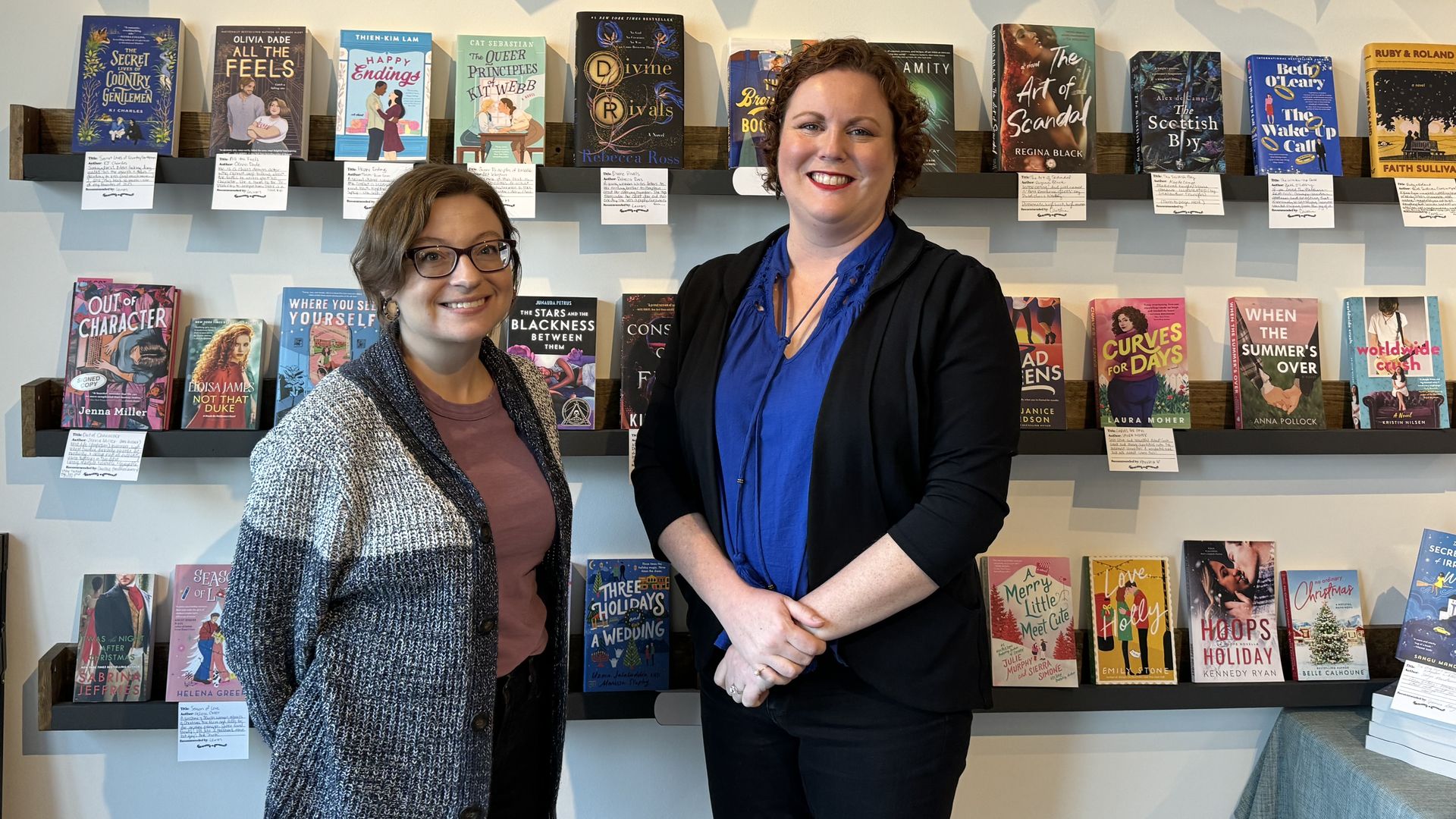 Caitlin O'Neil and Lauren Richards stand in their book store 