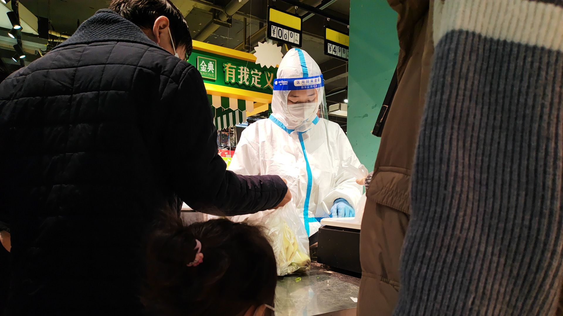 A cashier in PPE works in a supermarket in Zhengzhou in central China's Henan province Friday, Nov. 11.