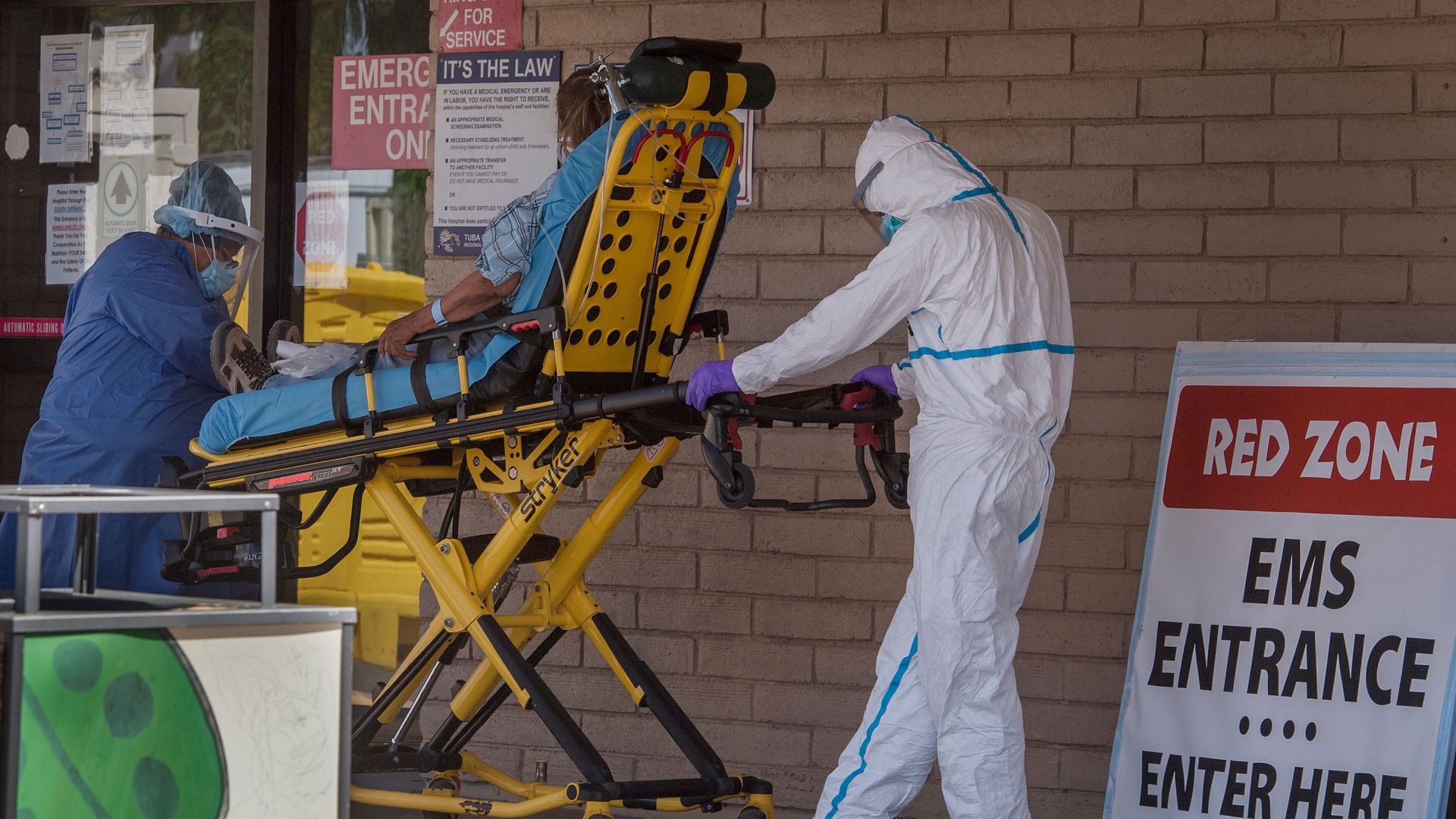 A patient is taken from an ambulance to the emergency room of a hospital in the Navajo Nation town of Tuba City