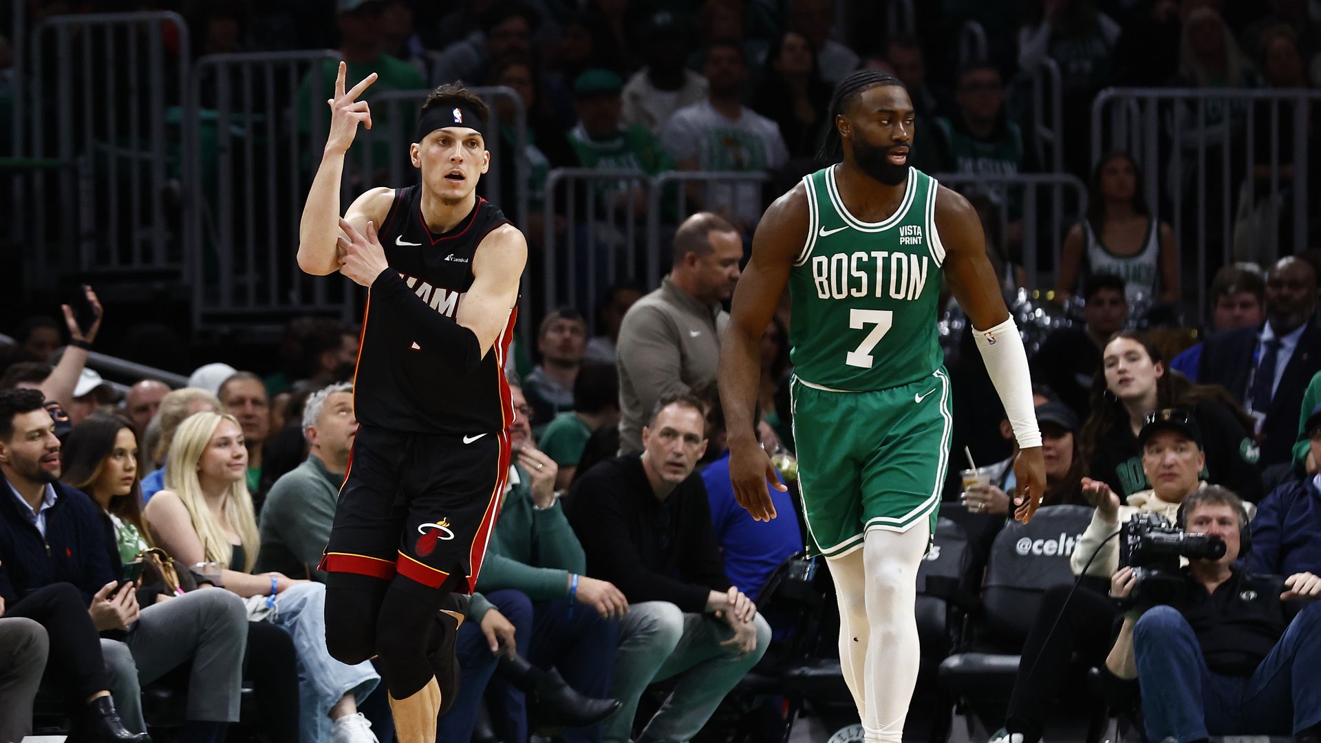 Tyler Herro #14 of the Miami Heat celebrates a three-point basket as he runs past Jaylen Brown #7 of the Boston Celtics