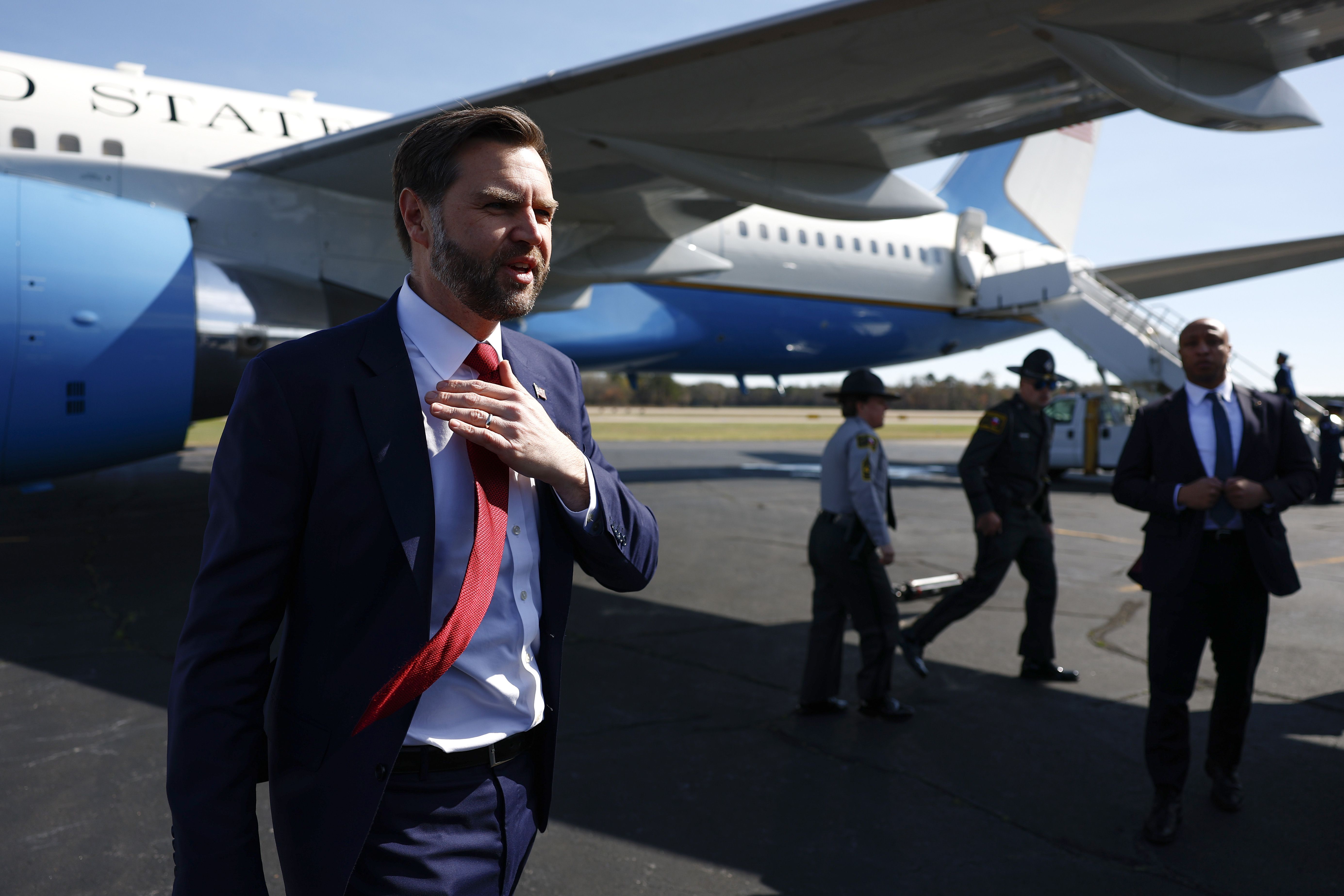U.S. Vice President JD Vance straightens his tie in front of Air Force Two at Rocky Mount-Wilson Regional Airport.