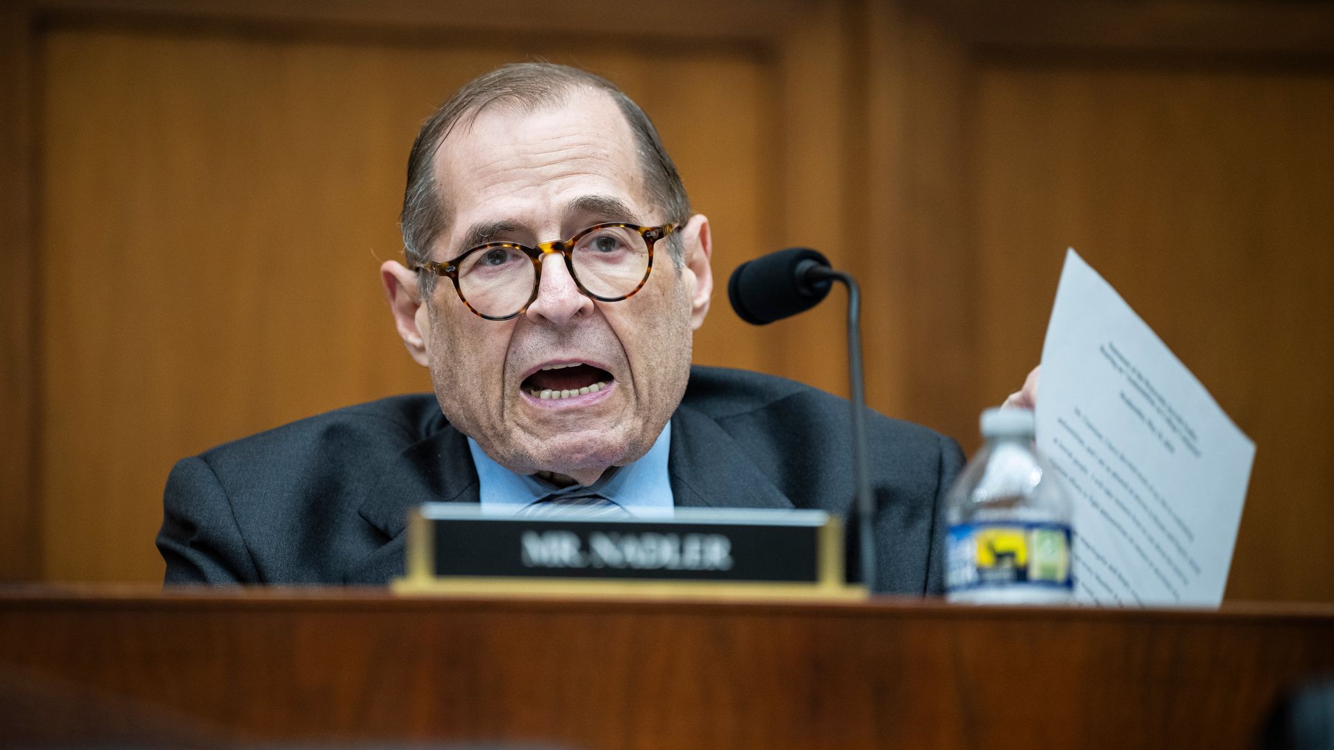 Jerry Nadler, wearing a gray suit, speaking microphone at a wooden dais in front of a wooden wall.