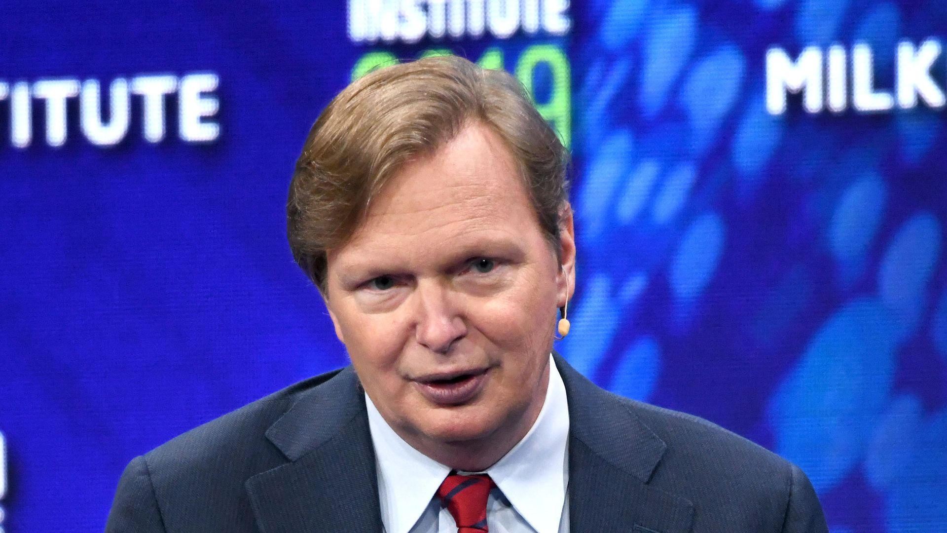 Jim Messina, on stage in a suit and tie