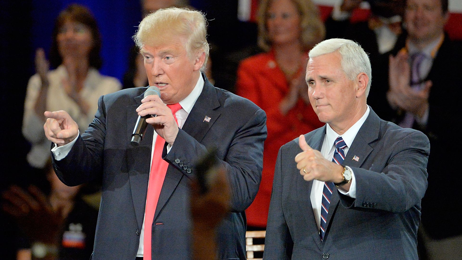 In this image, Trump and Mike Pence stand next to each other in suits.