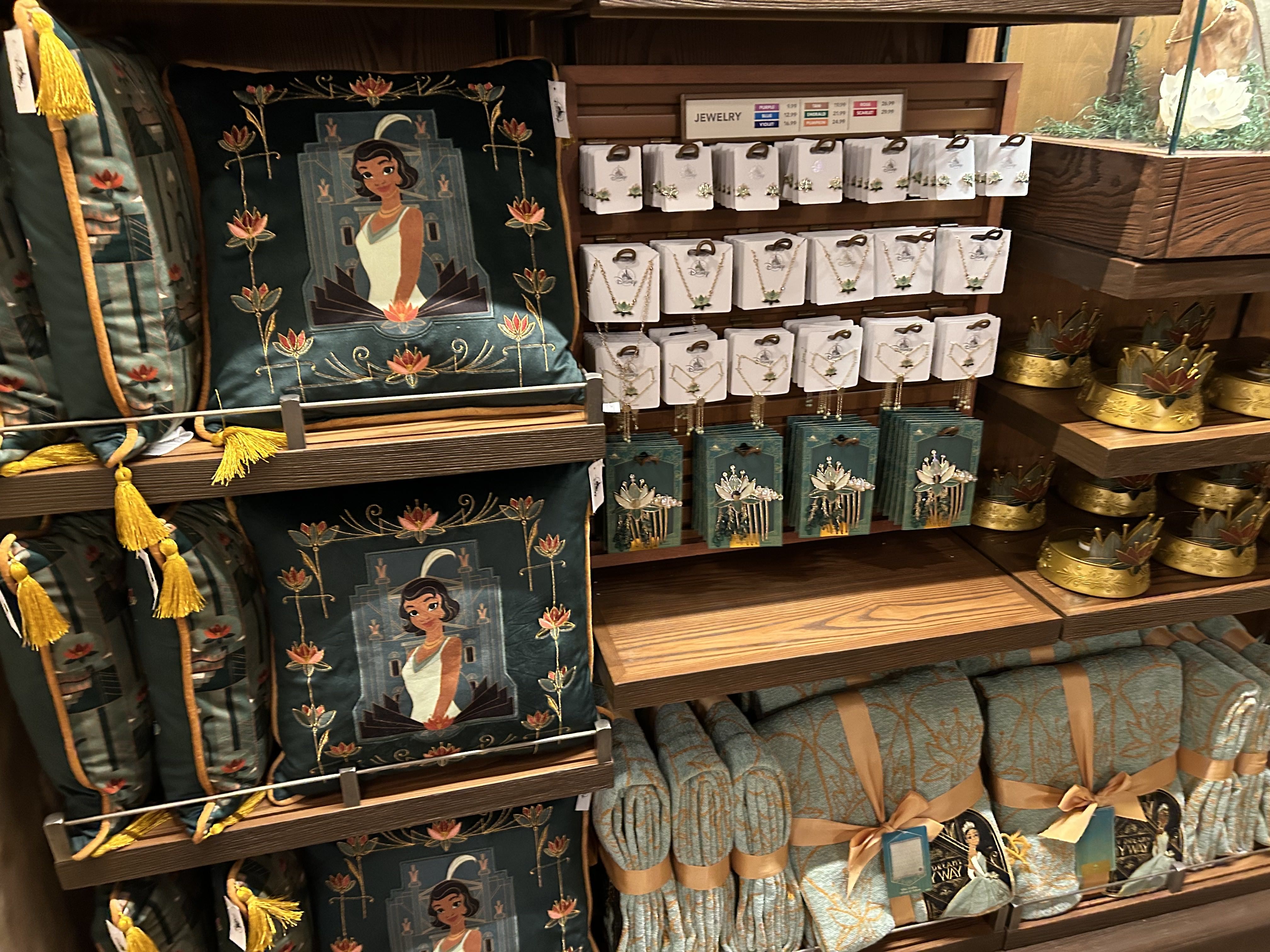 A rack of merchandise including jewelry, pillows and blankets.