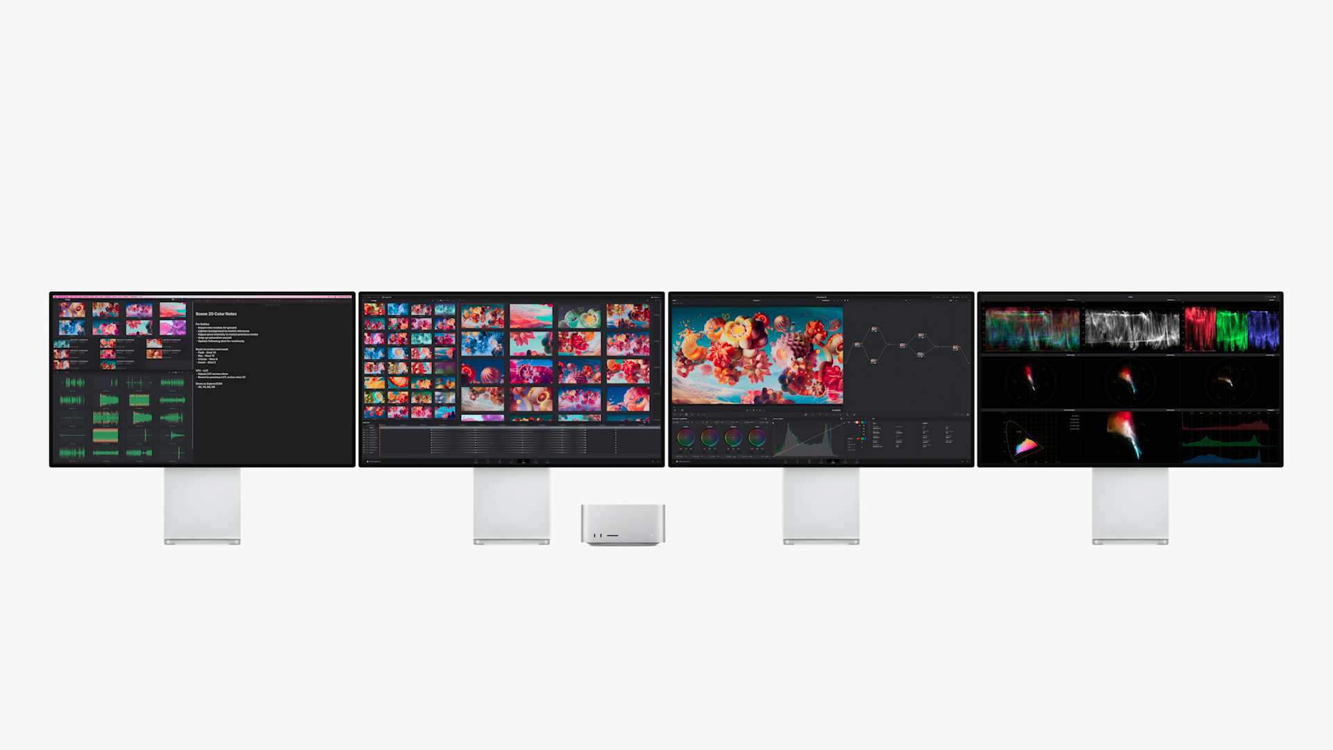 Apple's new Mac Studio along side several Studio Display monitors