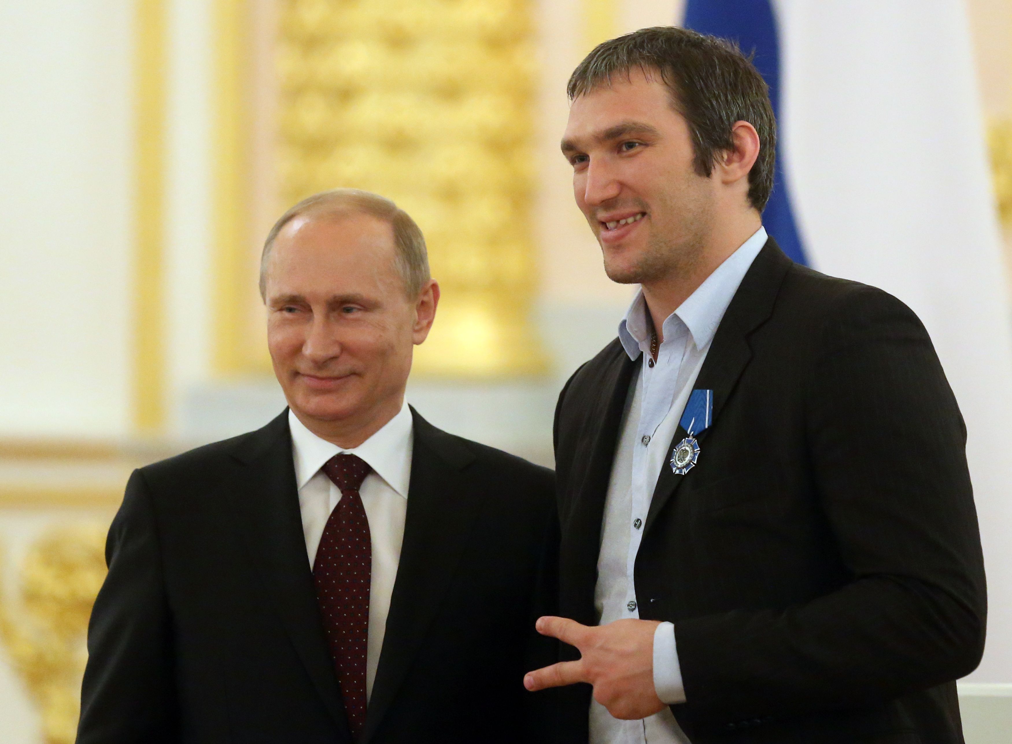 Russian President Vladimir Putin (L) and Russian Ice Hockey team player Alexander Ovechkin (R) stand together during a reception for national team who won the 2014 Ice Hockey World Championshon, in the Kremlin May 27, 2014 in Moscow, Russia. The Russian team met with Putin after a parade through the
