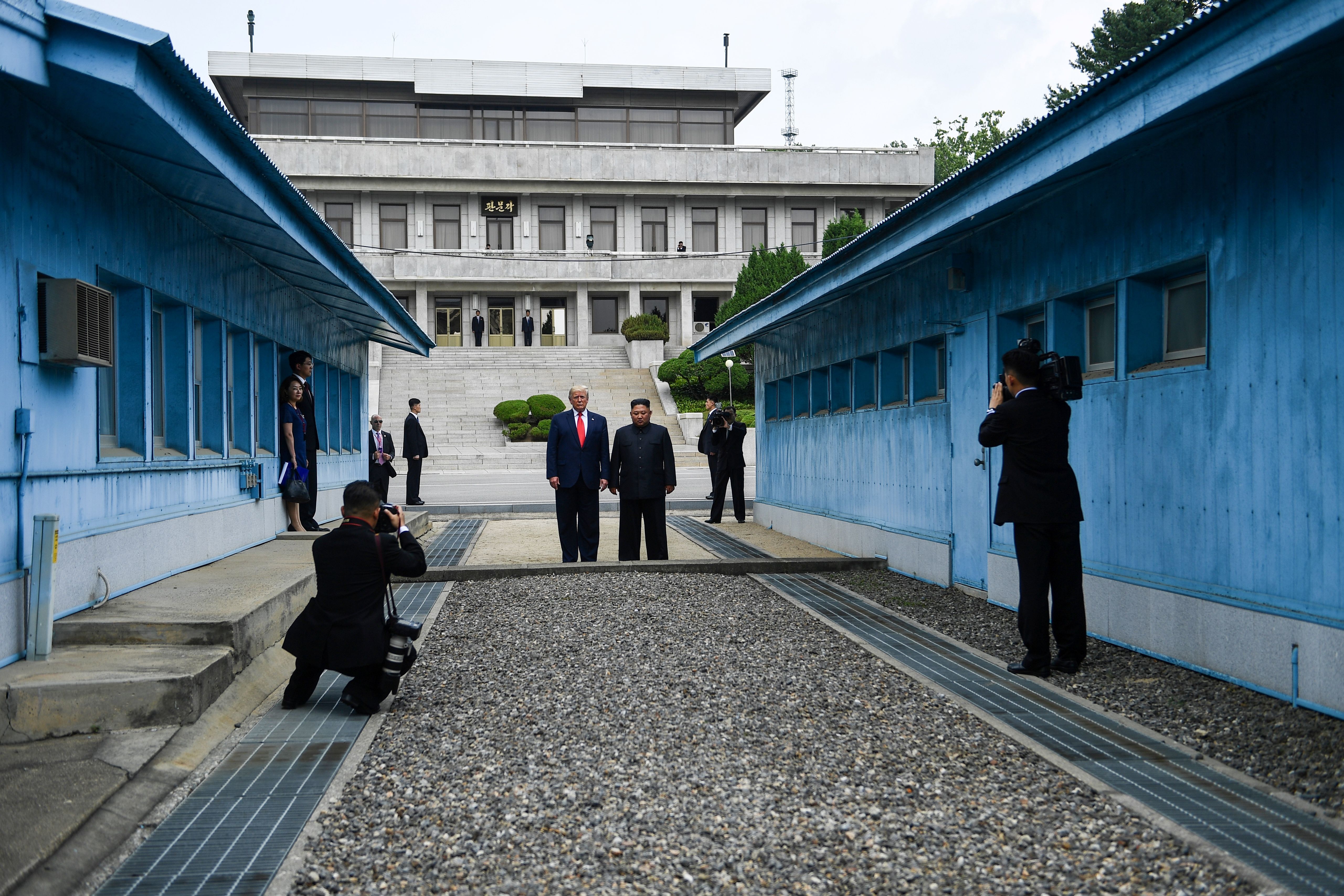   North Korea's leader Kim Jong Un stands with US President Donald Trump stand at the DMZ.