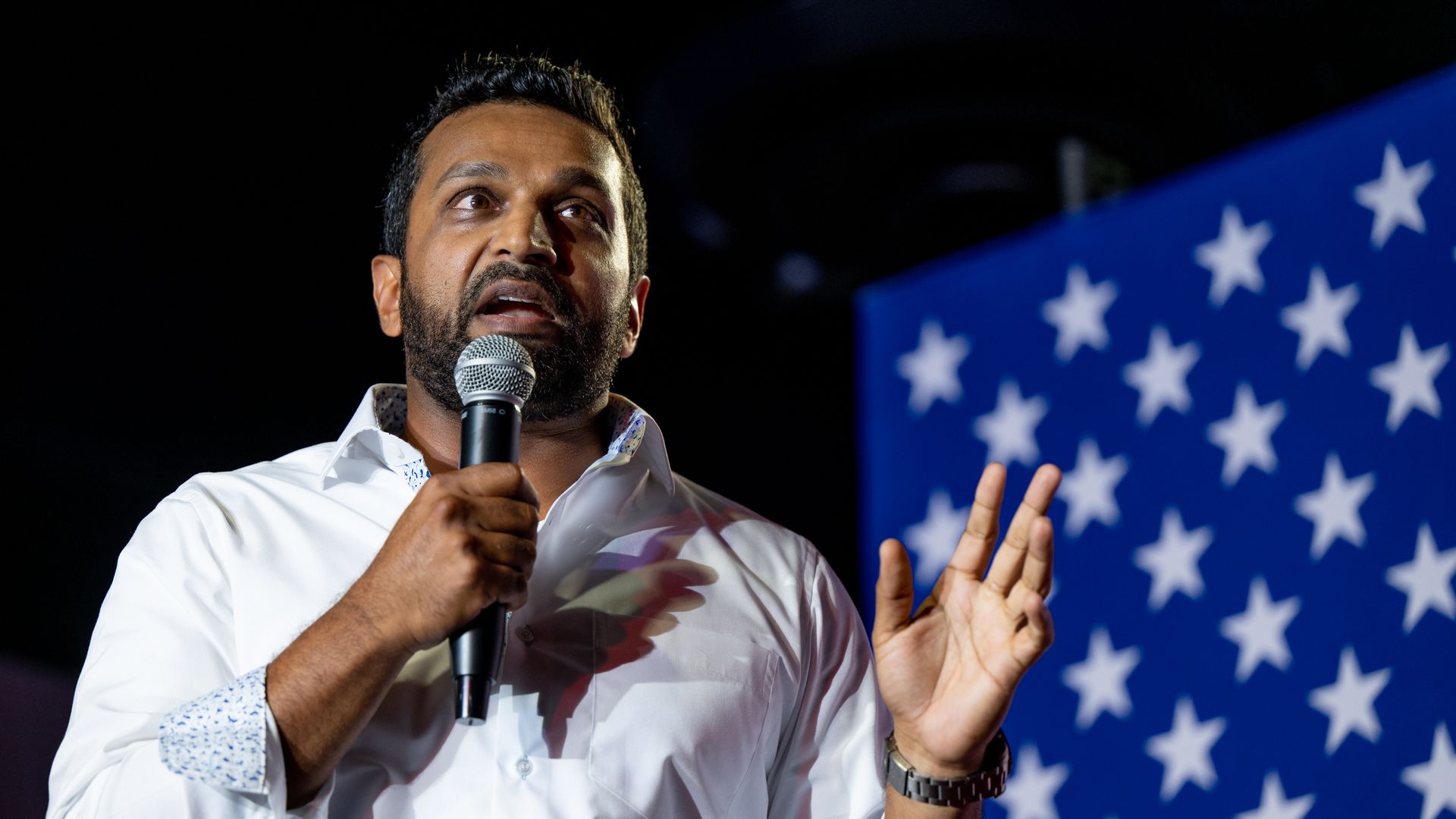 Kash Patel holding a microphone