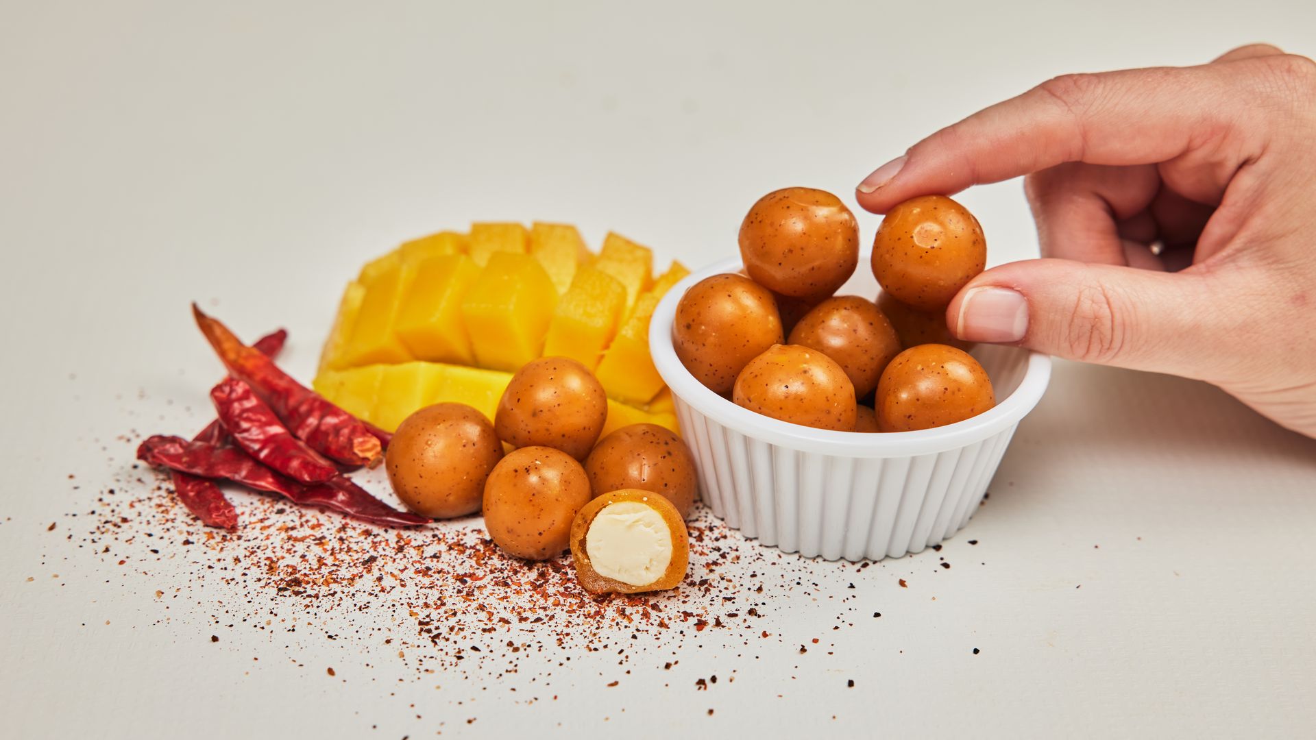 Bite-sized balls of cheese are coated in Foodberry's edible packaging.