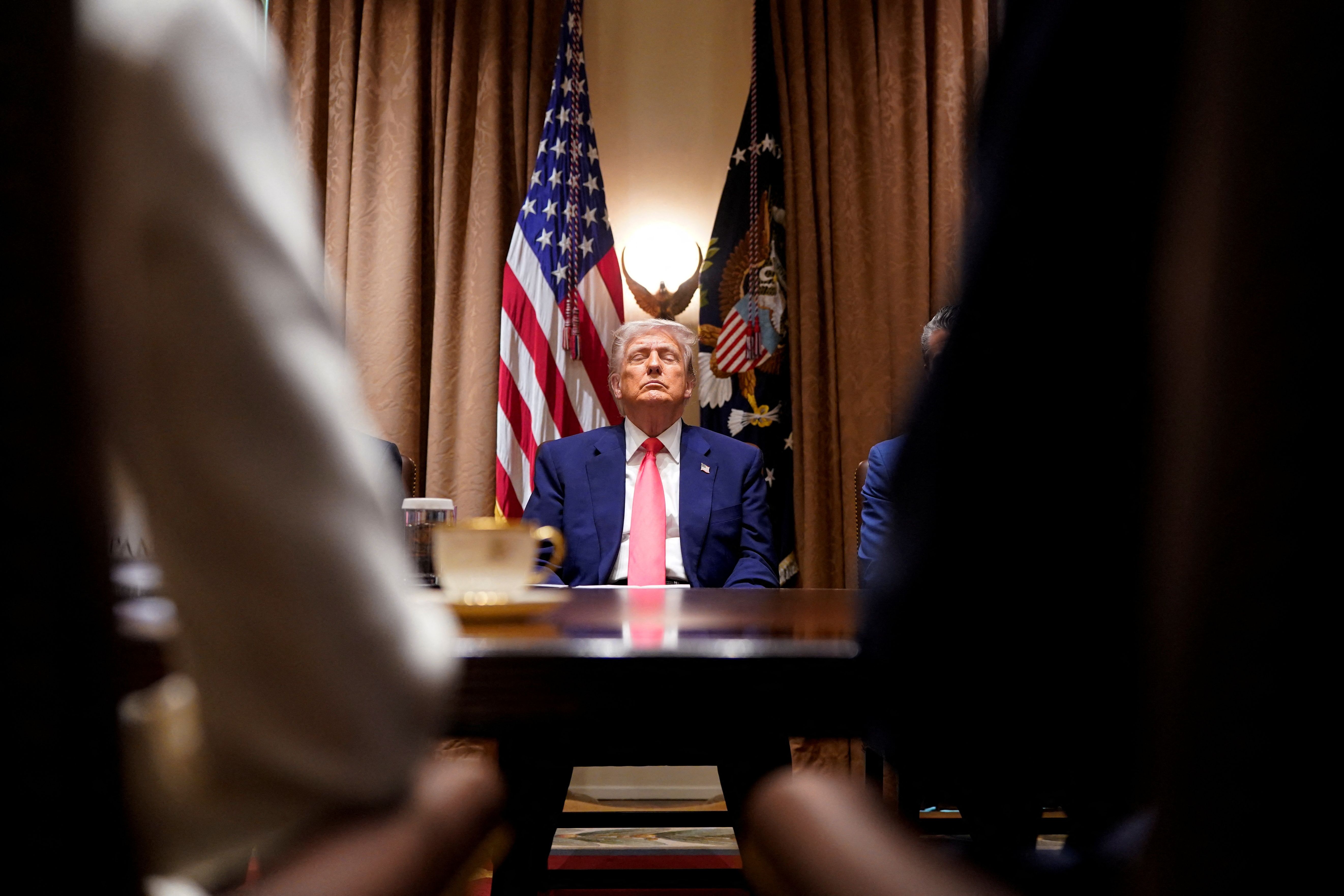 President Trump attends a cabinet meeting at the White House yesterday.