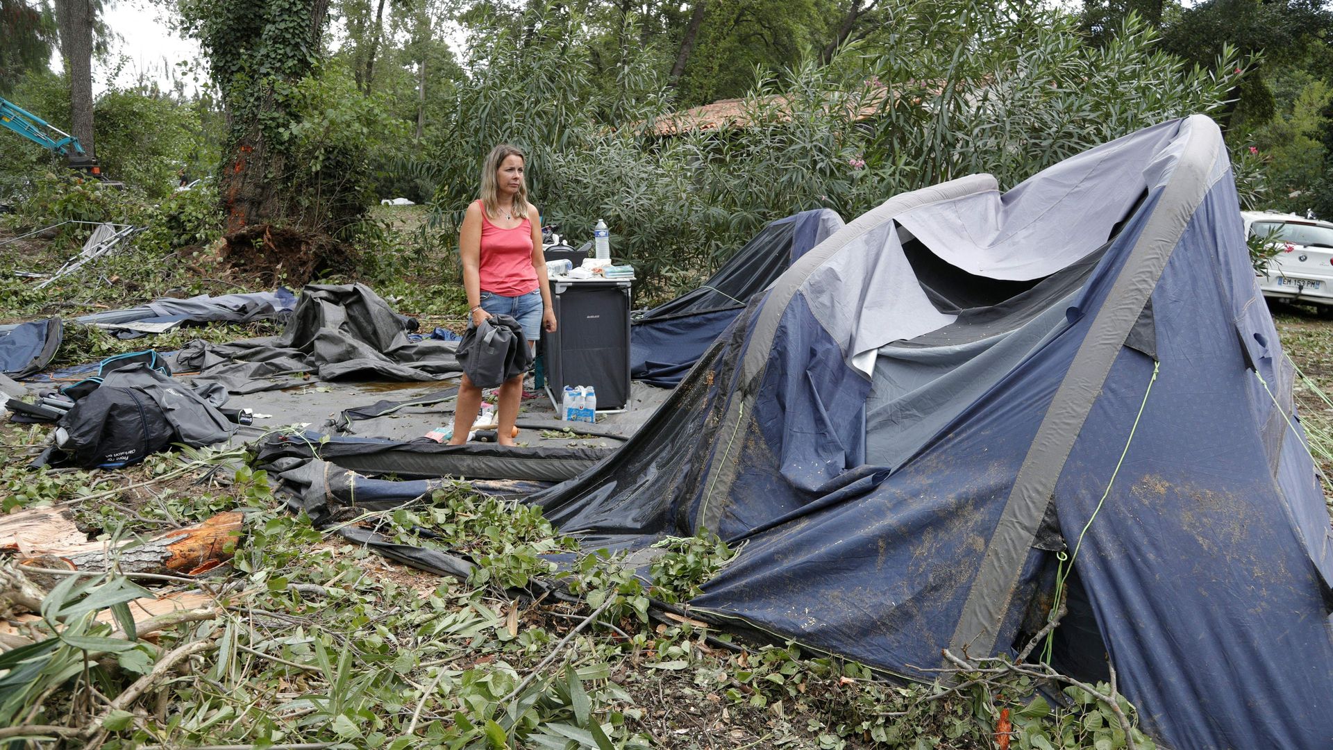 Campers pack what is left of their destroyed tents and other items  in Sagone on August 18, 2022, on the French Mediterranean island of Corsica. 