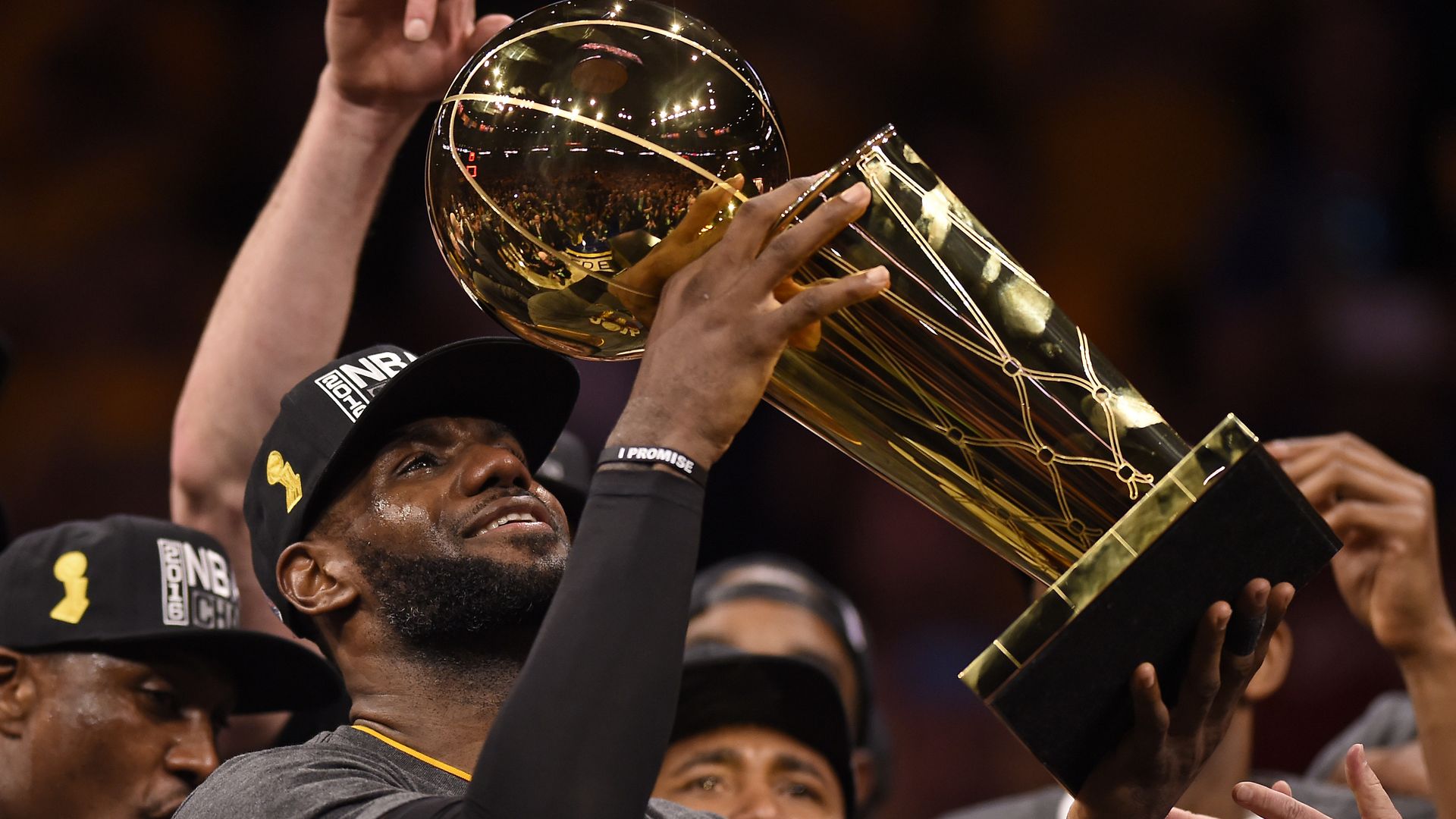 LeBron James holds up the NBA Championship trophy. 