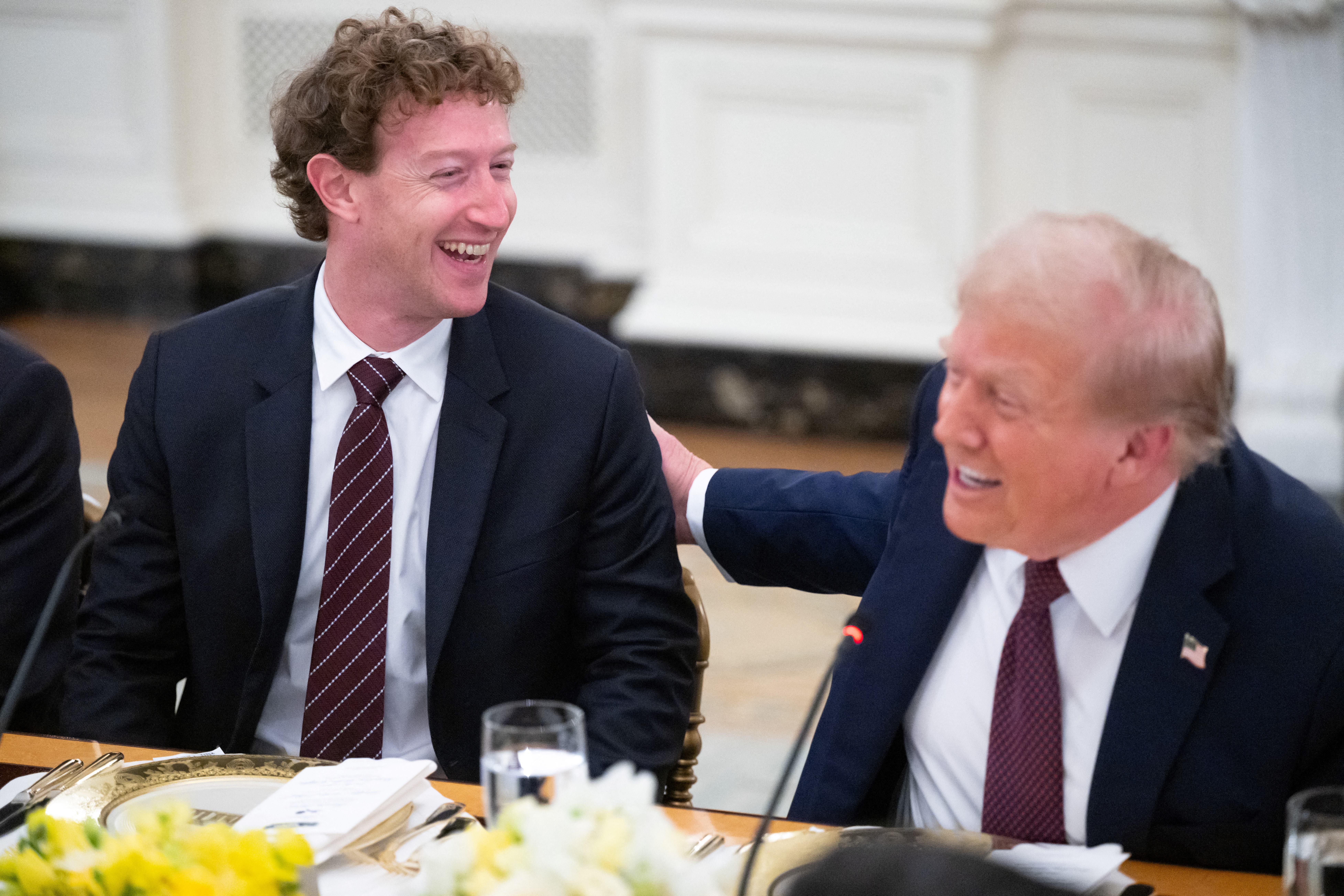 US President Donald Trump jokes with Meta CEO Mark Zuckerberg (L) as he hosts tech leaders for a dinner in the State Dining Room of the White House in Washington, DC, on September 4, 2025. (Photo by SAUL LOEB / AFP) (Photo by SAUL LOEB/AFP via Getty Images)