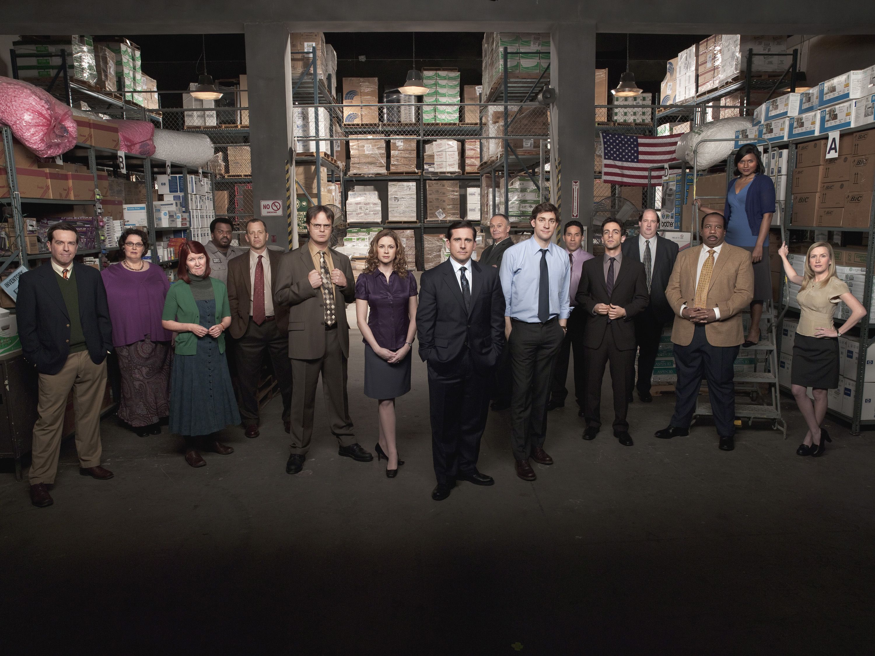 People standing in front of shelves piled high with boxes