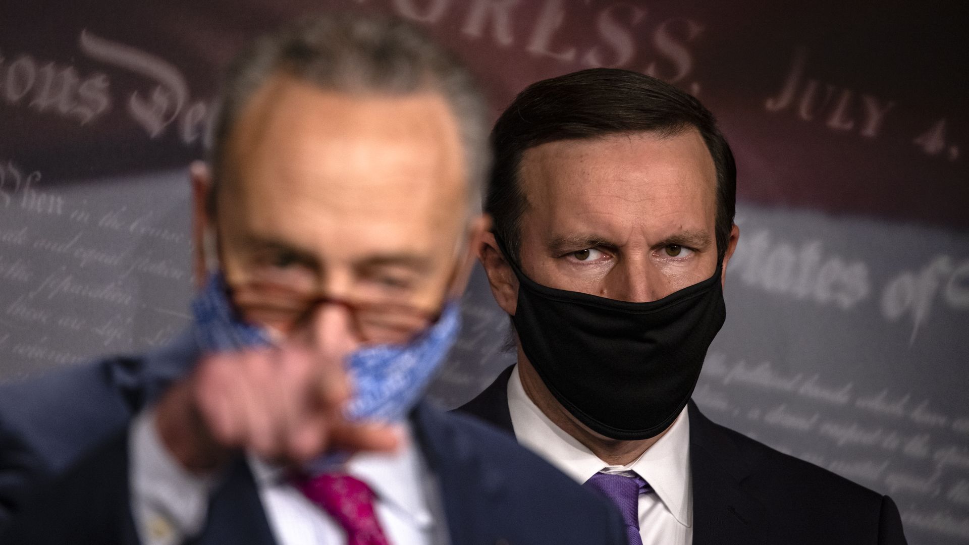 Sen. Chris Murphy looks on as Senate Majority Leader Chick Schumer speaks.