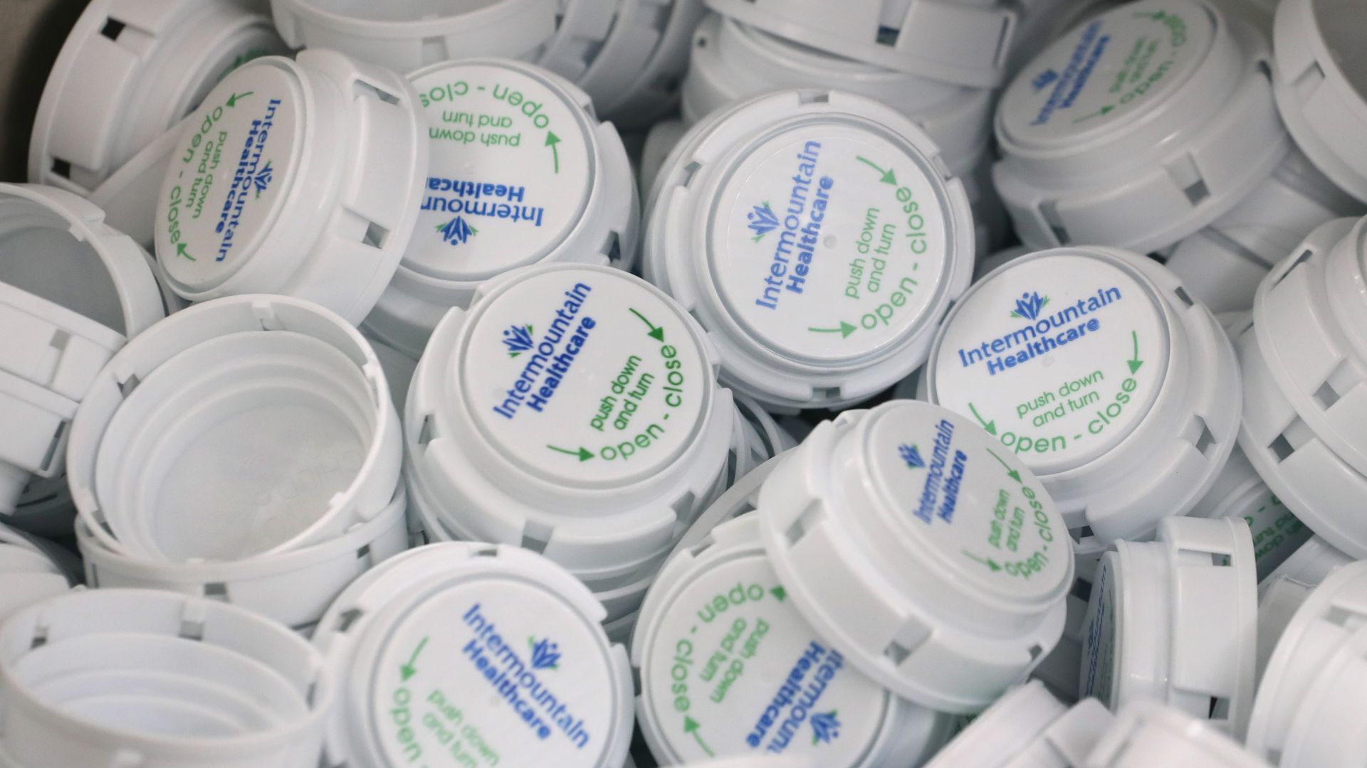 A box of prescription pill bottle caps.