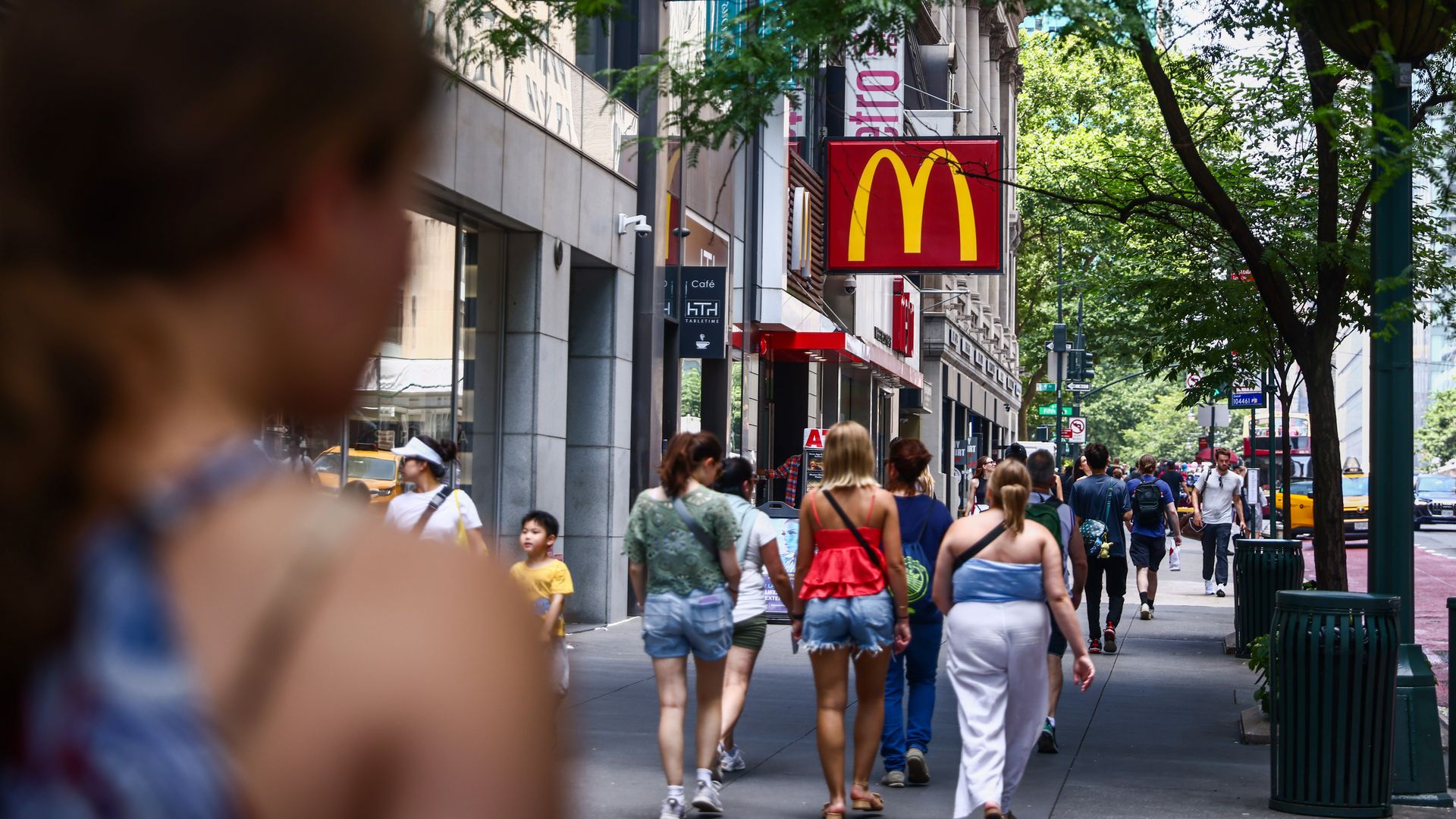 People walking in New York, with a McDonald's logo in the forefront