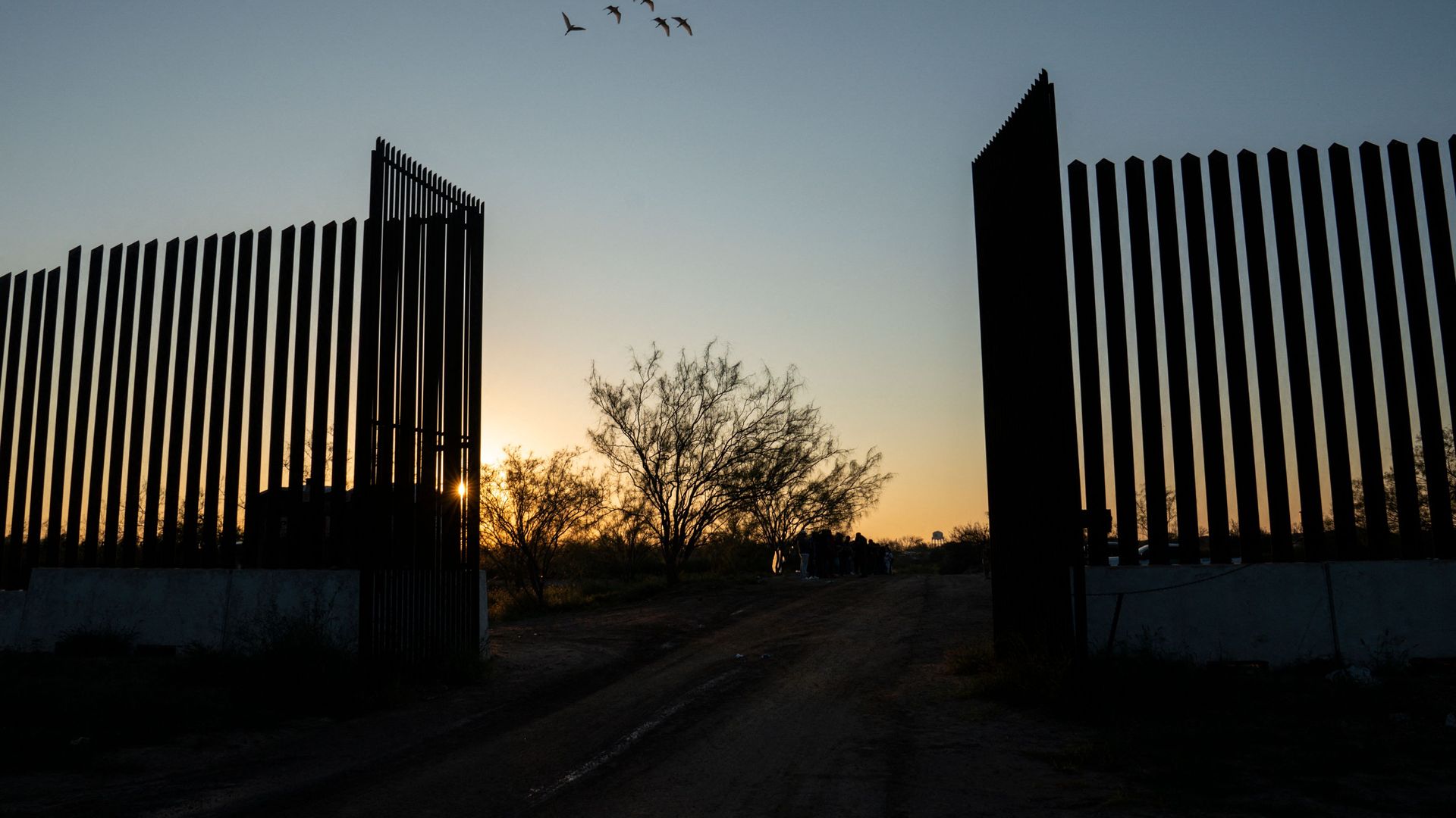 Migrants wait for their turn to board a Border Patrol van t