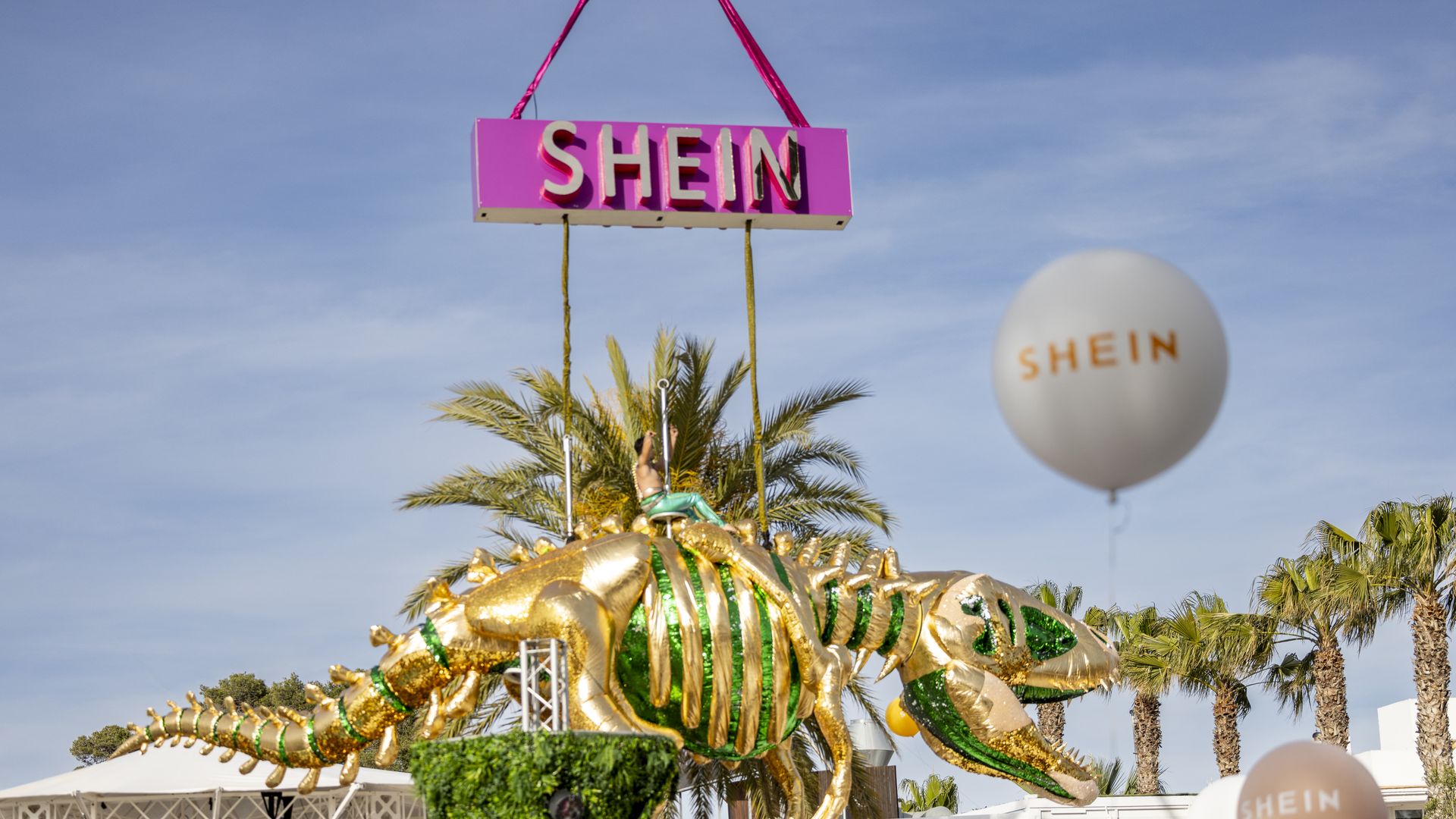 A Shein sign in pink hovers over its opening party at O Beach Ibiza in Spain on May 3.
