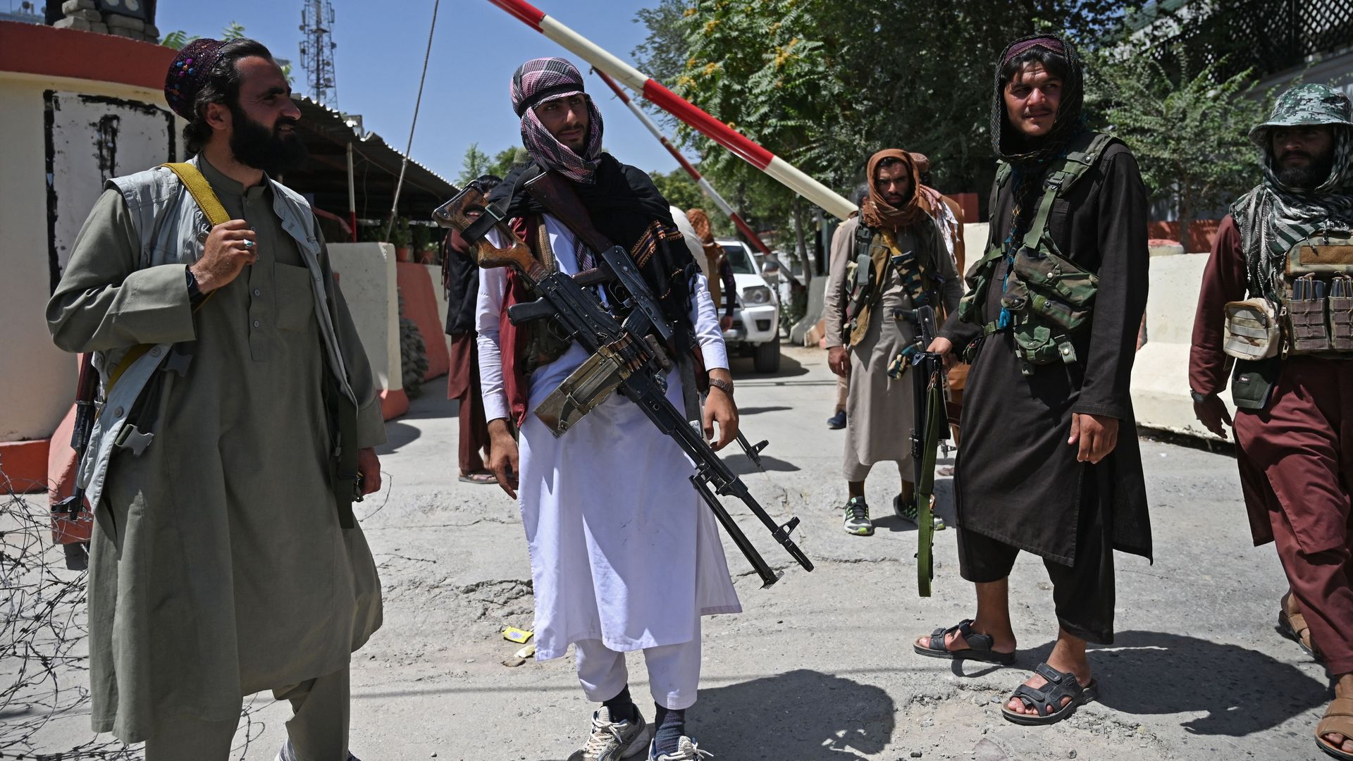  Taliban fighters stand guard along a roadside near the Zanbaq Square in Kabul on August 16