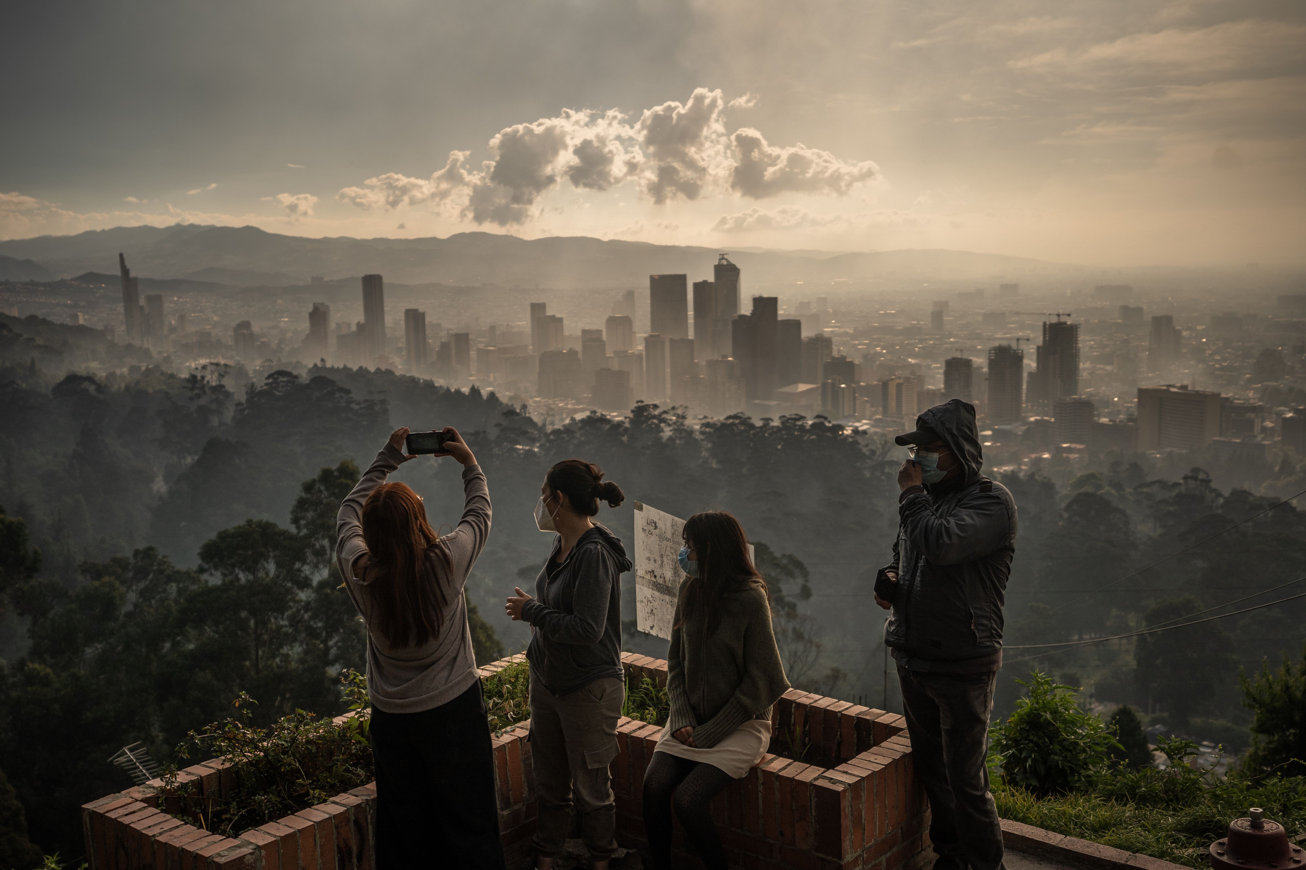 People taking photos above Bogota, with the air extremely hazy from smoke. 