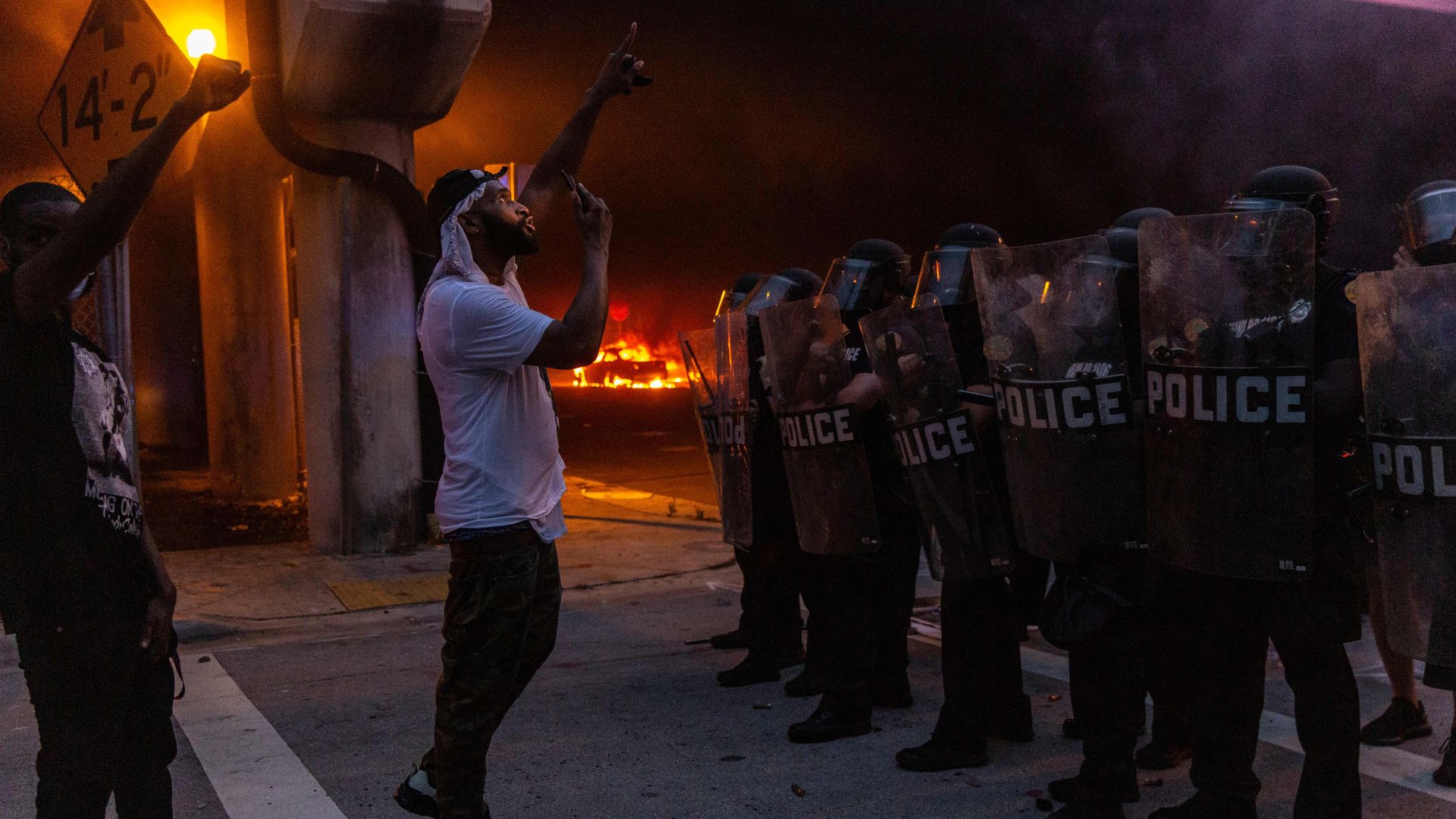 Protesters confronting police in riot gear in May 2020 in Miami, Florida, during demonstrations over the death of George Floyd.