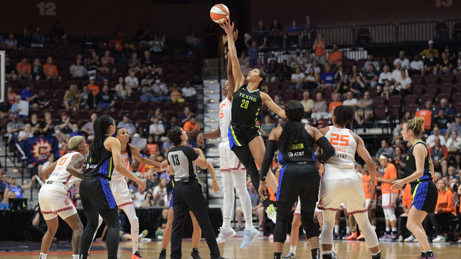 Isabelle Harrison (20) reaches for the ball during the tipoff against Connecticut Sun forward Jonquel Jones (35) during Game 2.