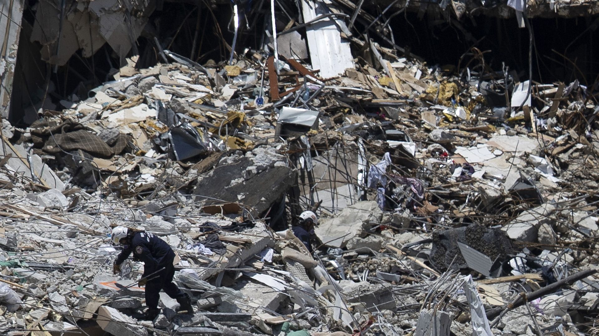 Search and Rescue teams look for possible survivors in the partially collapsed 12-story Champlain Towers South condo building on June 27, 2021 in Surfside, Florida. 