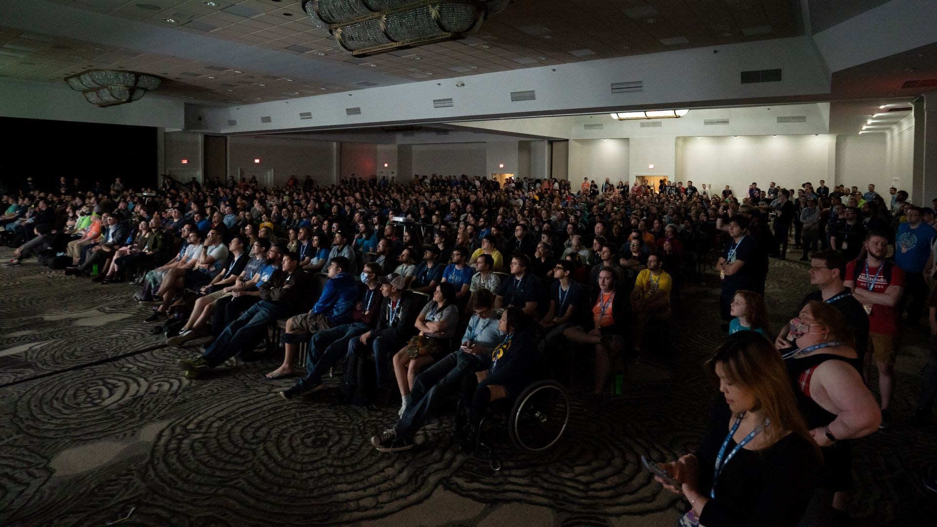 Photo of a crowd of people sitting in an auditorium