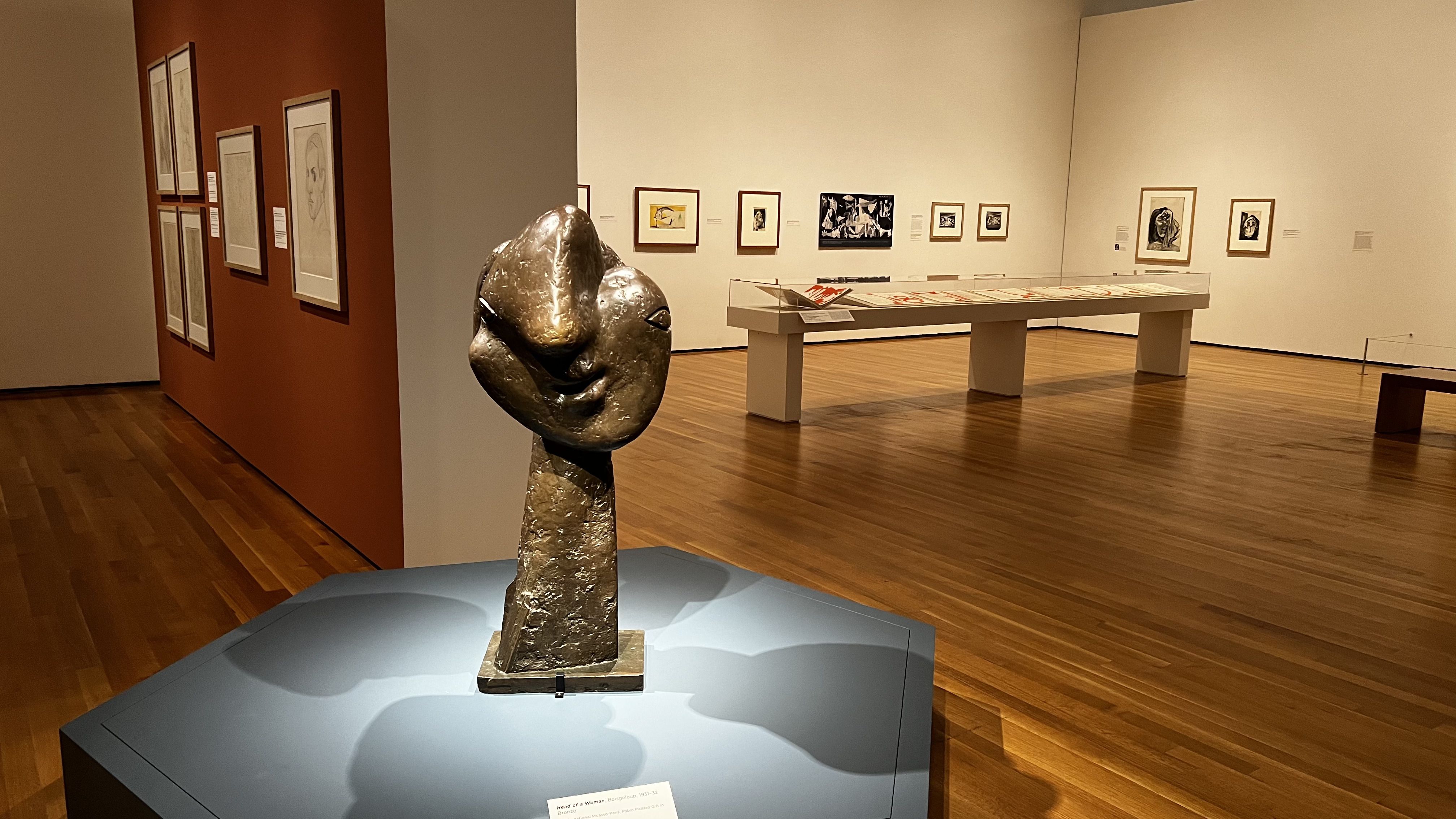 A sculpture at the center of a room. 