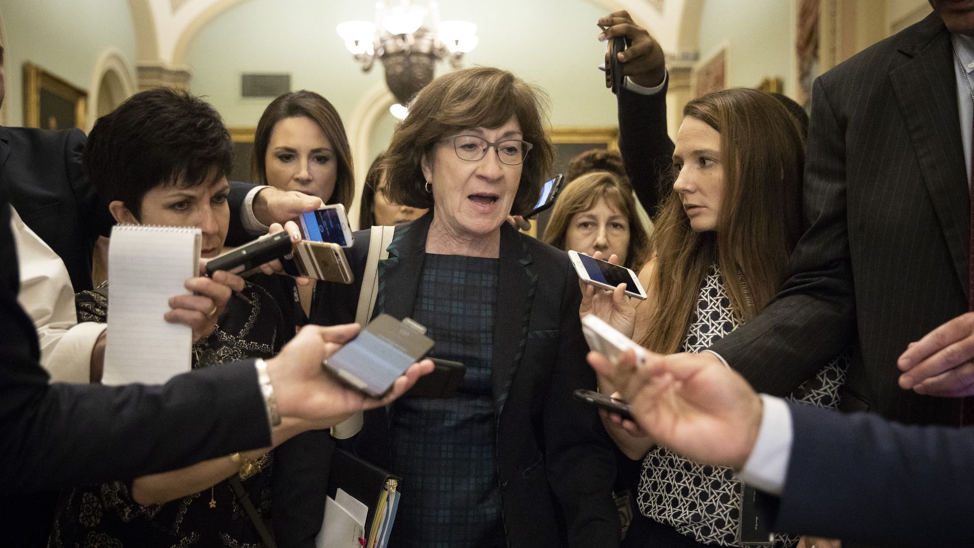 Sen. Susan Collins in a crowd of reporters