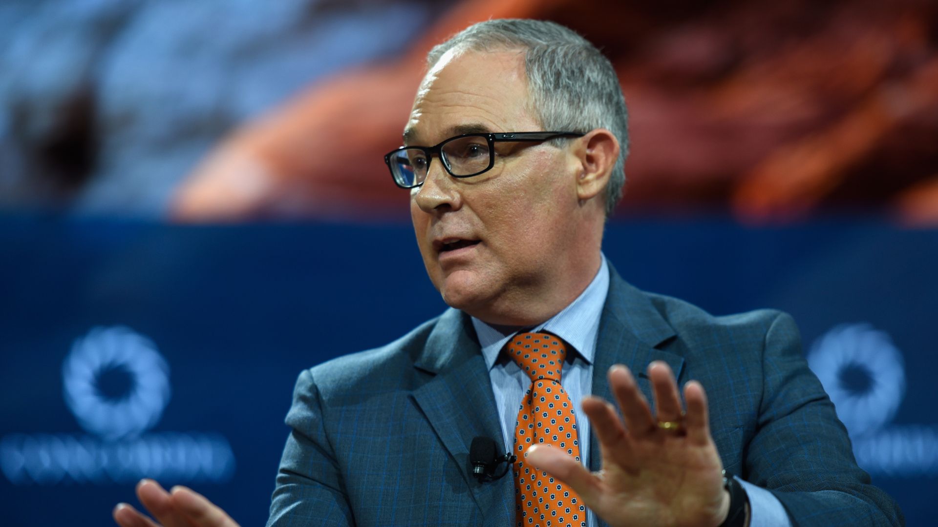 Scott Pruitt, head of the EPA, with his hands raised as if he's pushing someone away