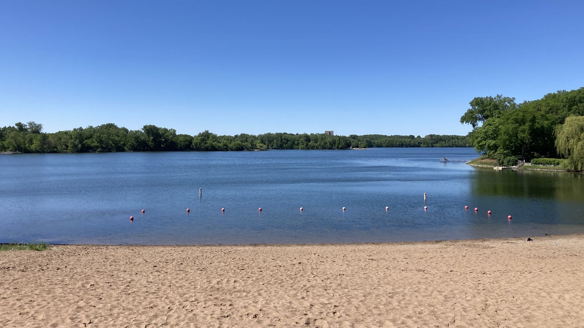 A beach with Cedar Lake in the background