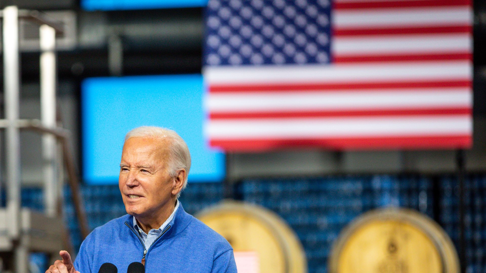 Joe Biden speaking in front of an American flag